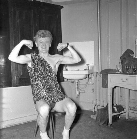 Man Flexing Muscles In Leopard Tunic