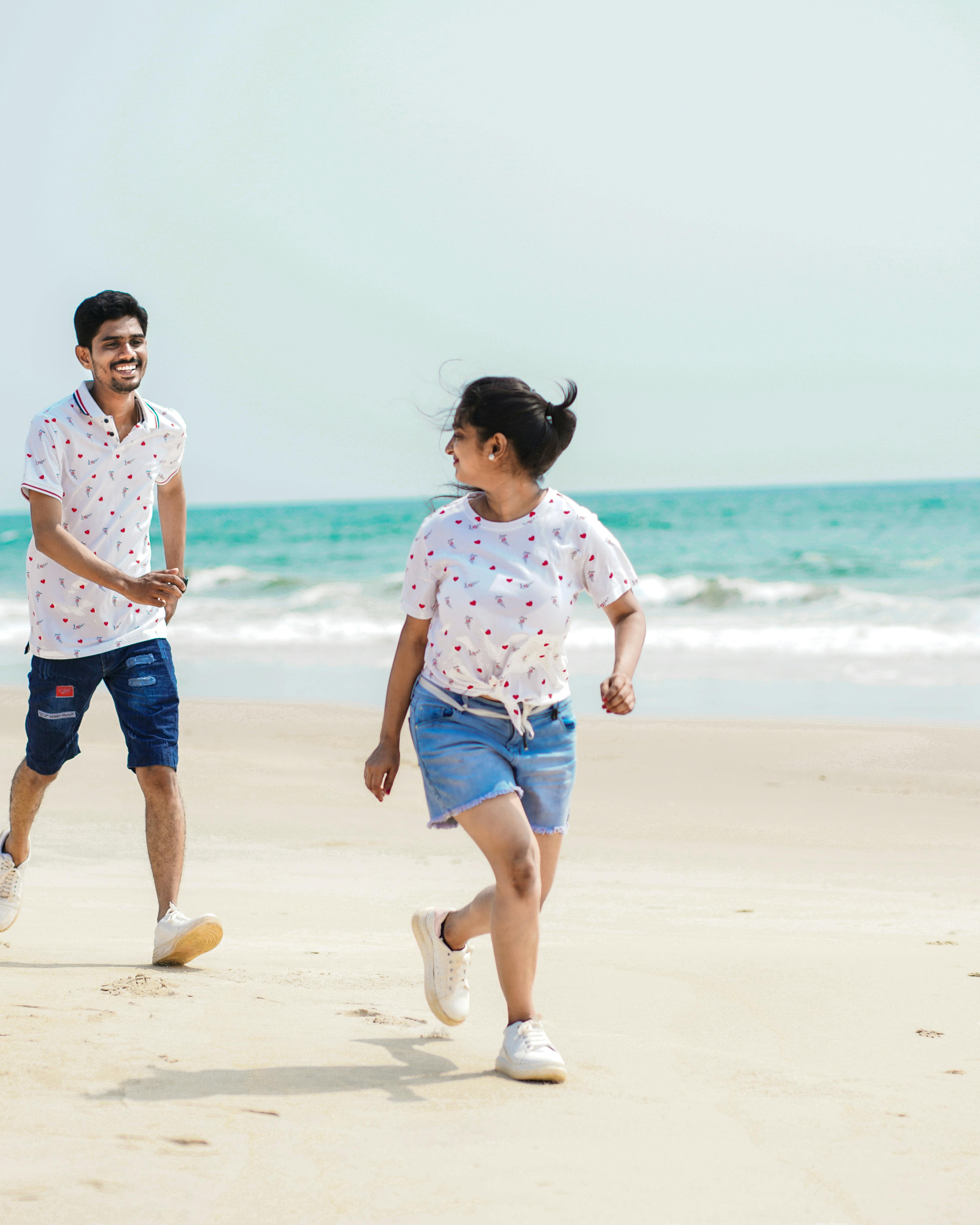 Couple Running On Sandy Beach