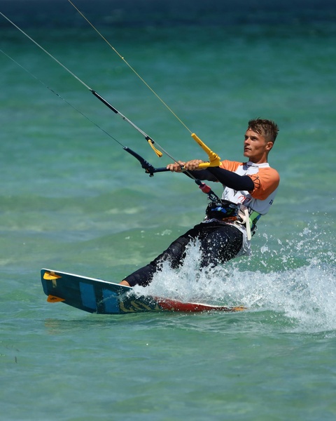 Man Kiteboarding on Turquoise Ocean