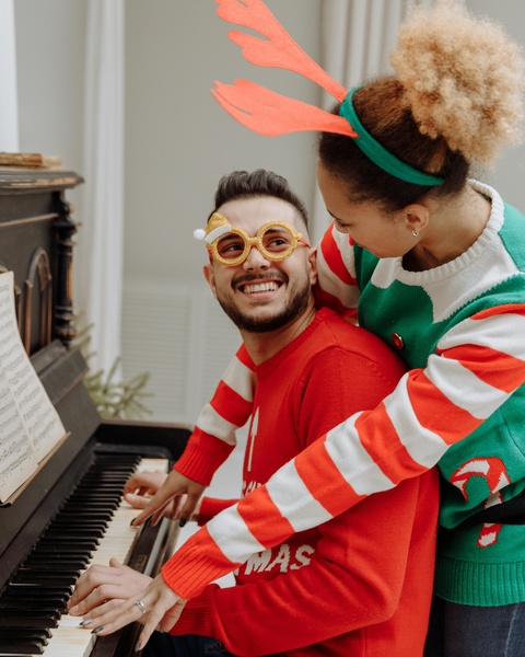 Festive Couple Playing Piano Together