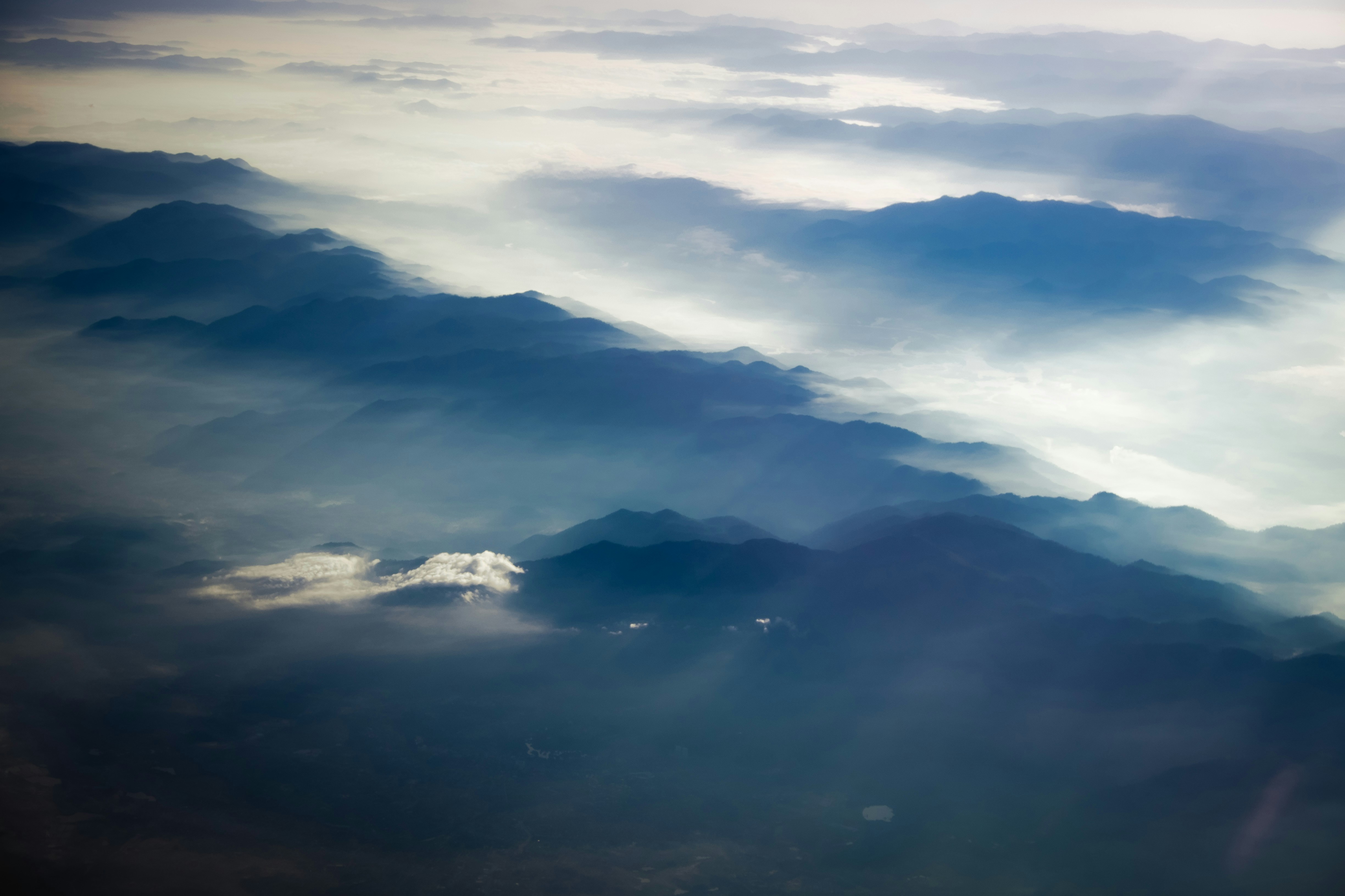 Aerial View of Misty Layered Mountains