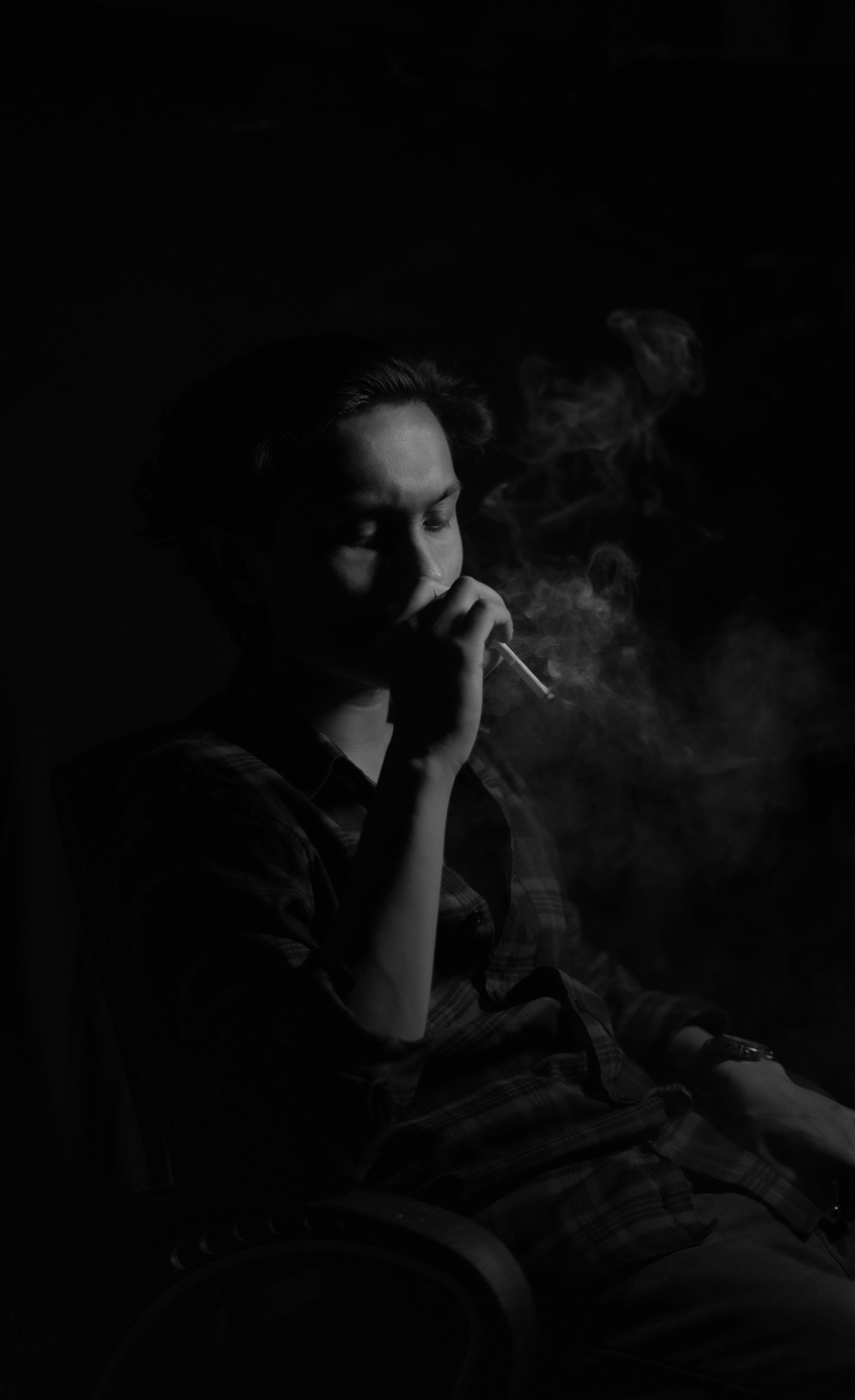 Young Man Smoking in Dark