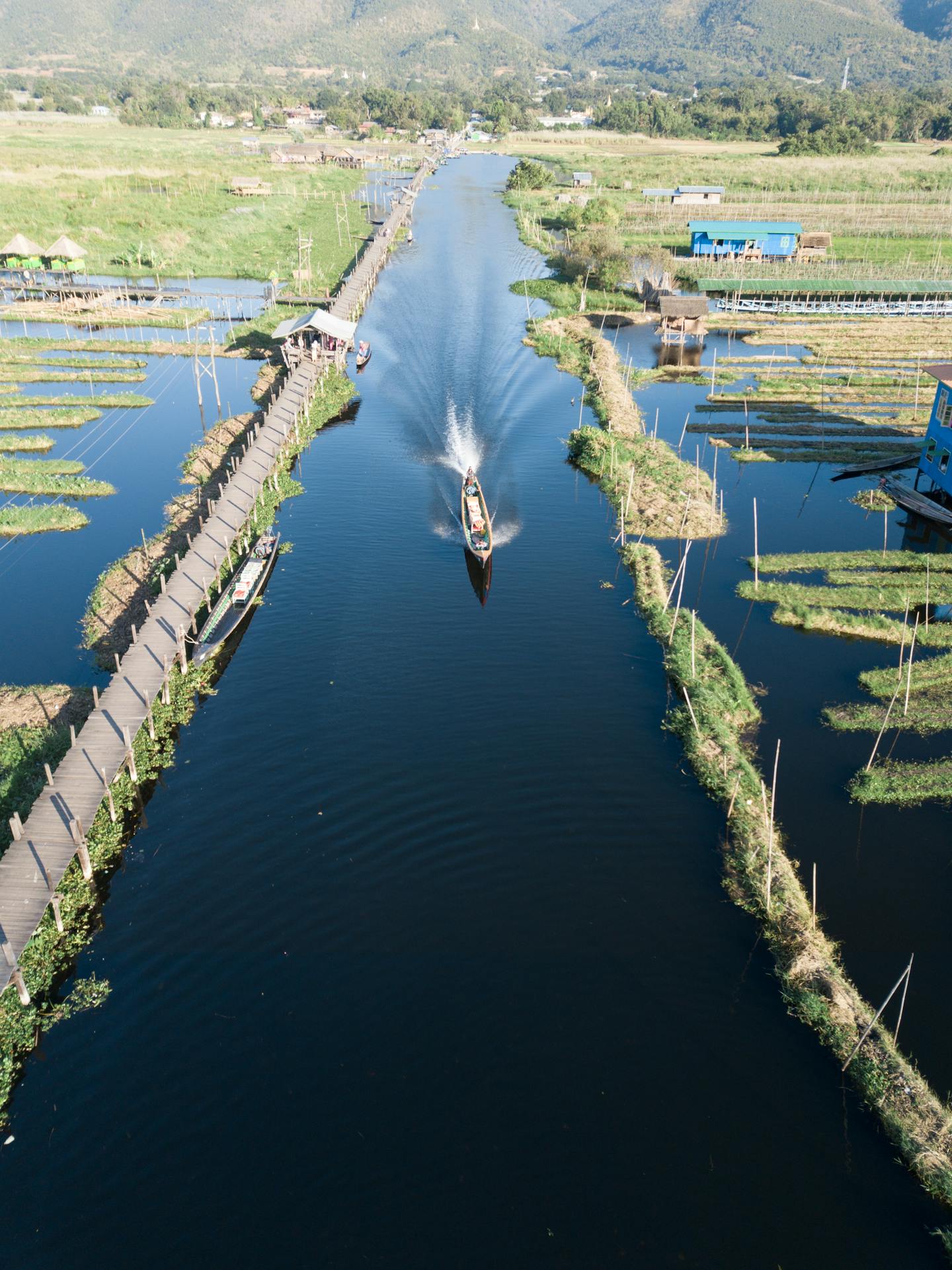 Boat on Canal with Floating Farms