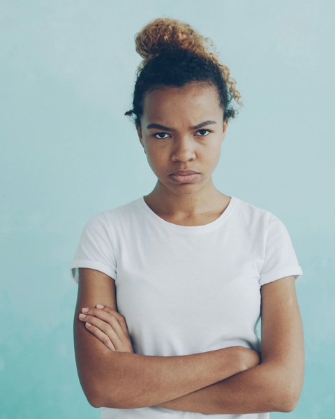 Upset Young Woman With Crossed Arms