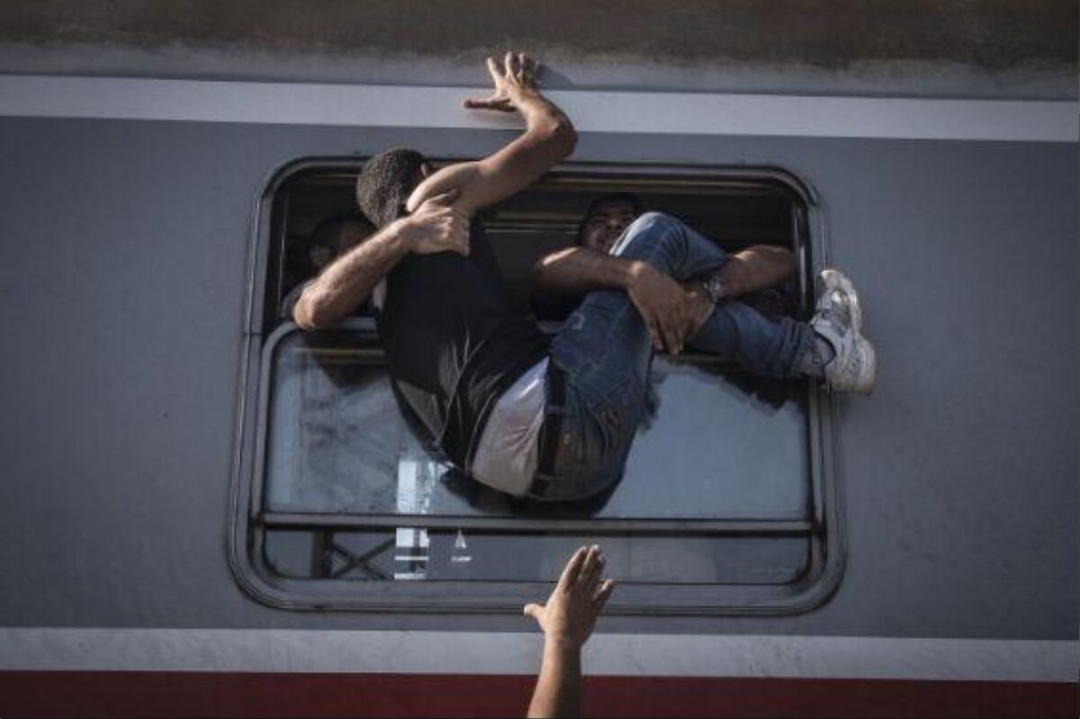 Man Trying to Squeeze Into Train Through Window