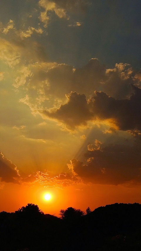 Sunset Behind Silhouetted Hills