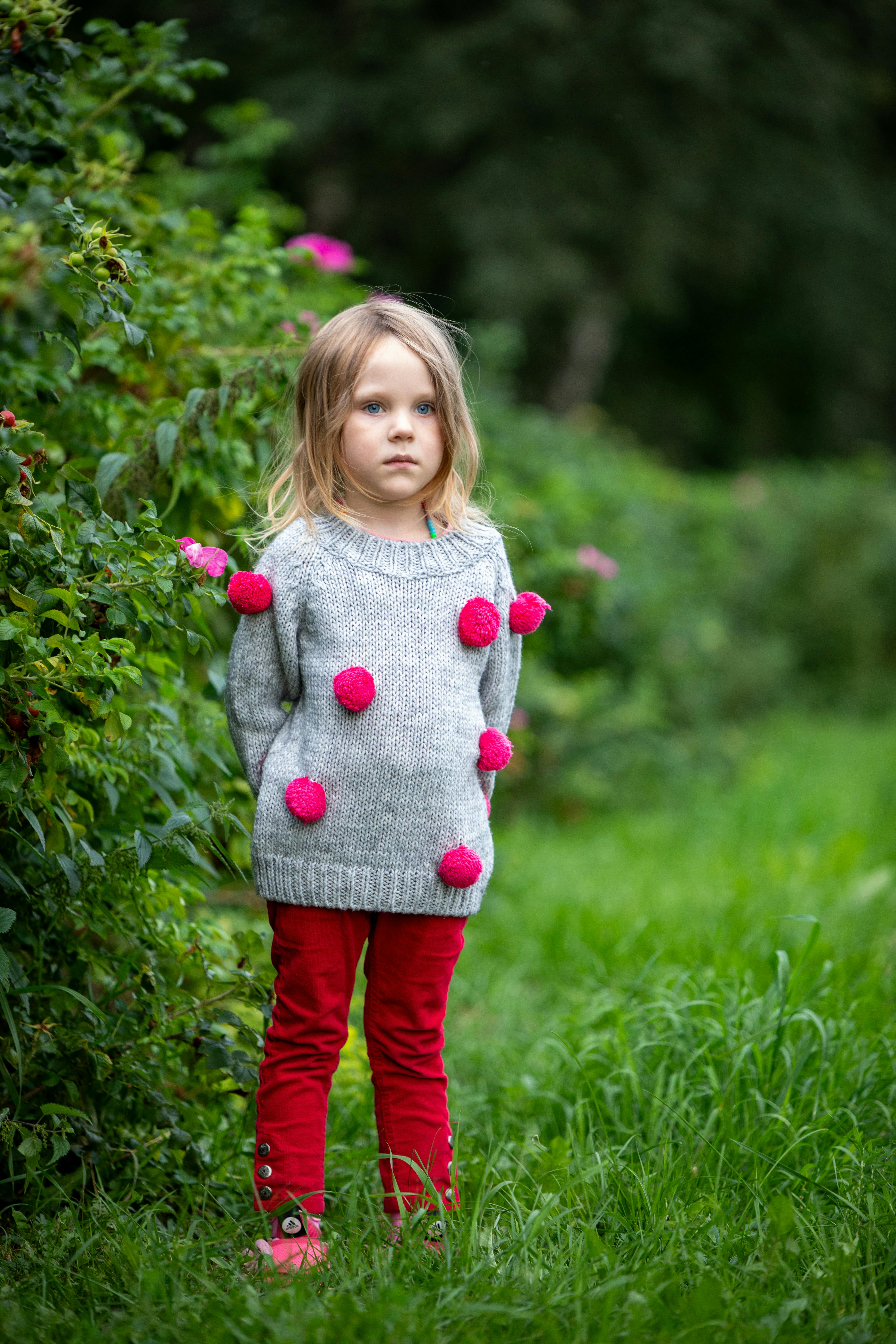 Little Girl in Lush Green Garden