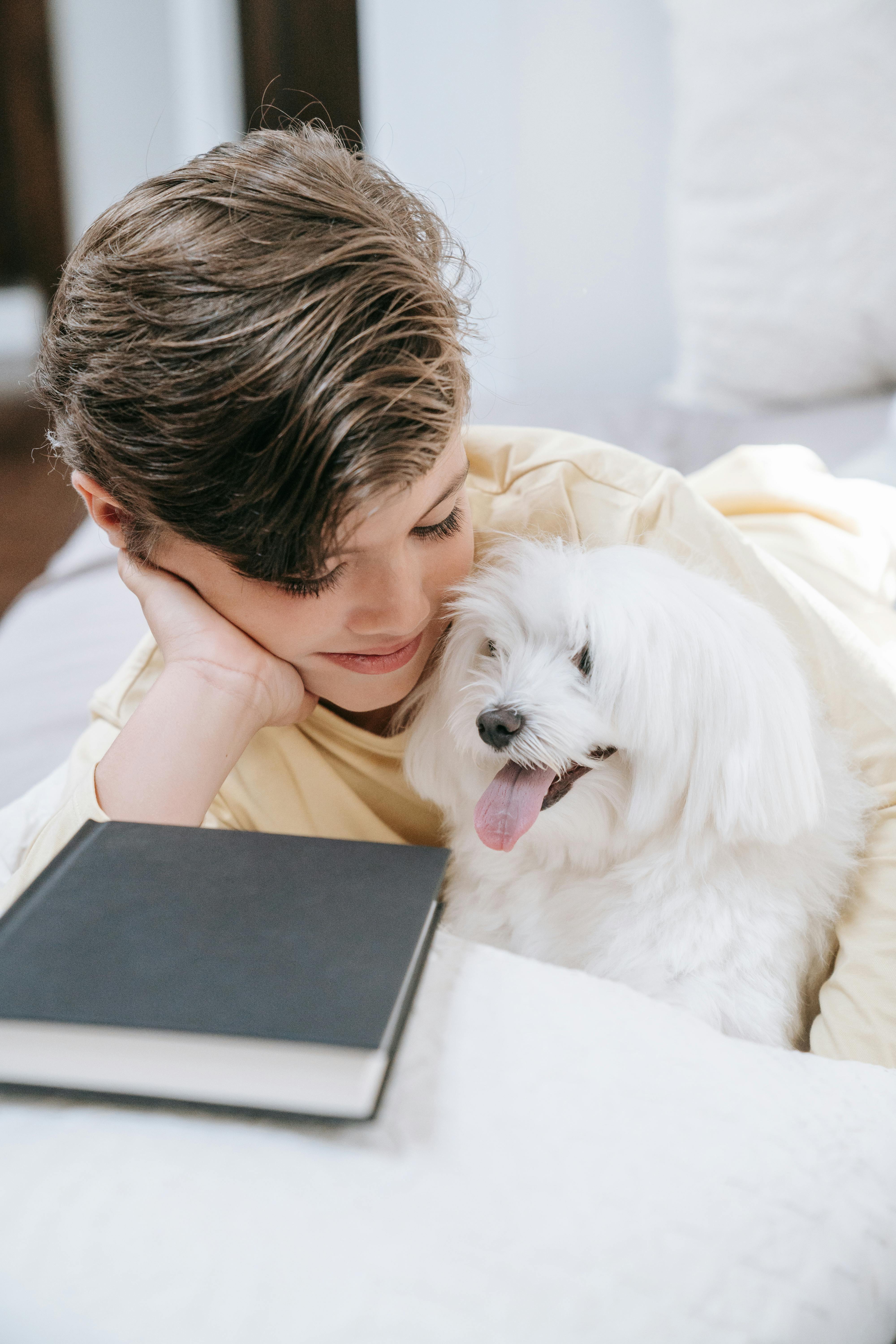 Boy Relaxing With Dog and Book