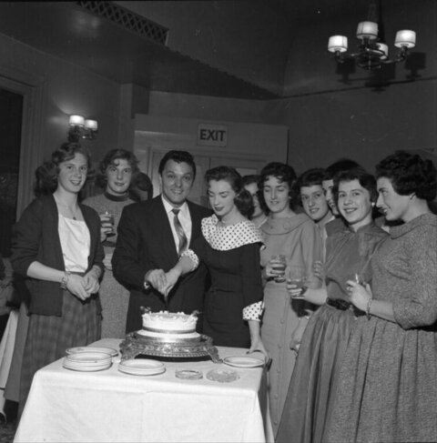 Vintage Couple Cutting Wedding Cake