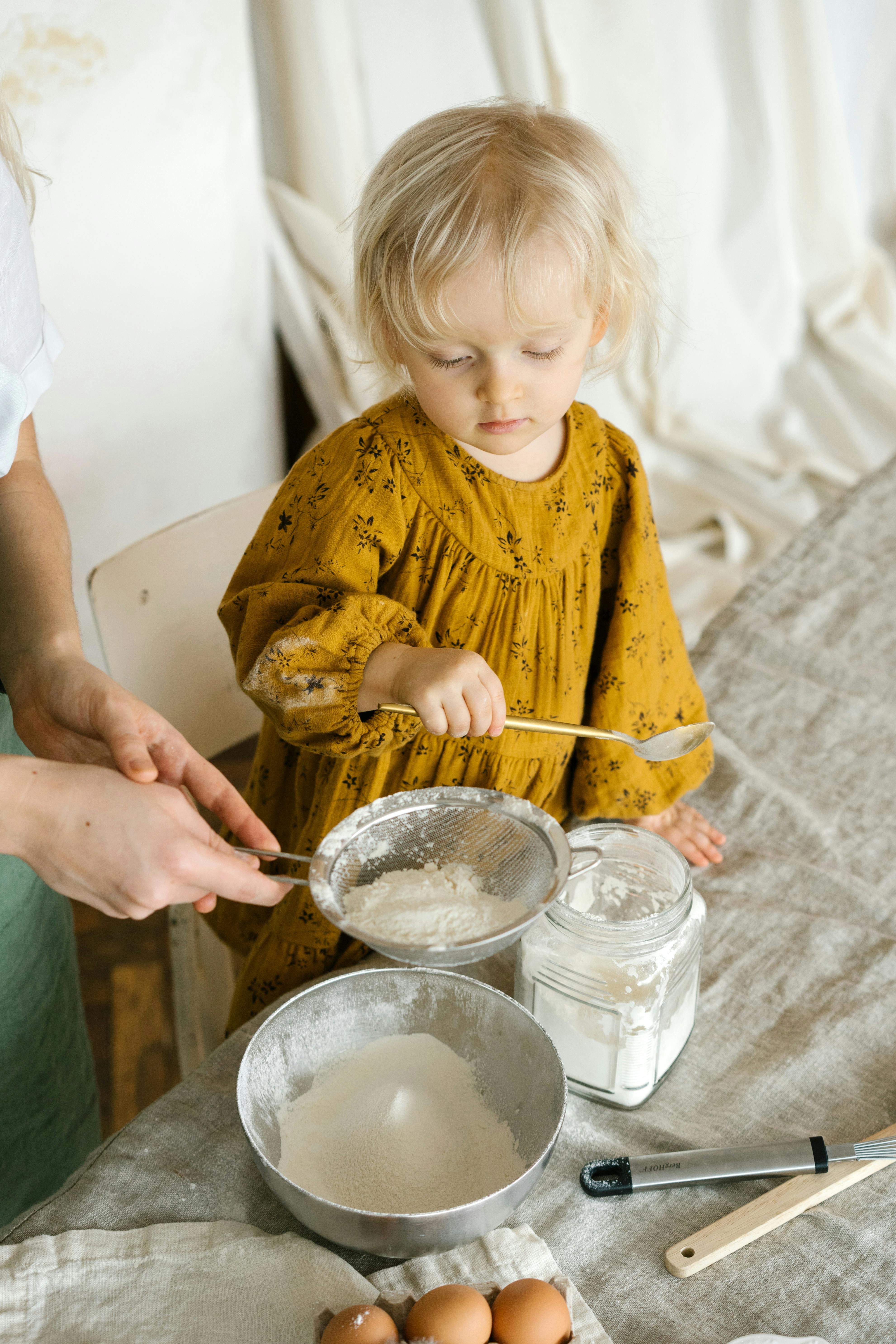 Toddler Helping Bake In Kitchen