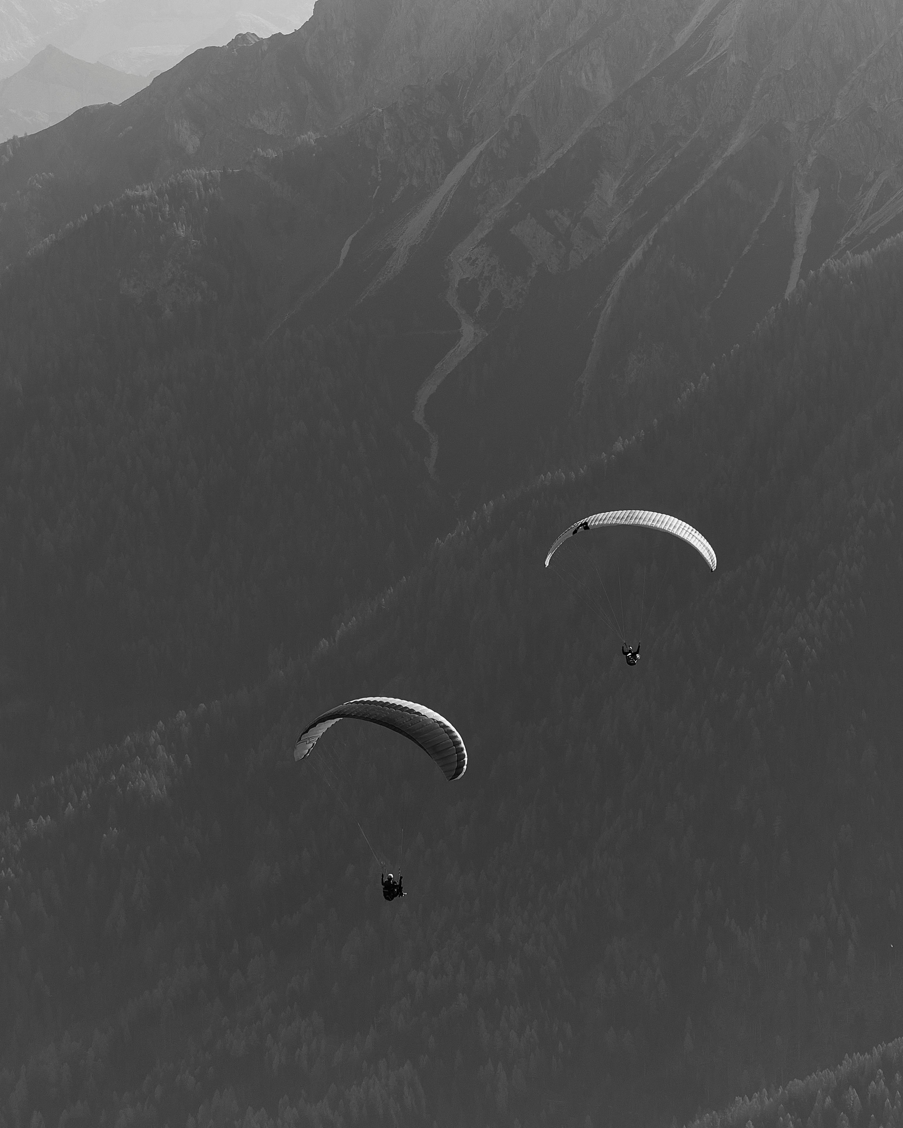 Two Paragliders Over Mountain Valley