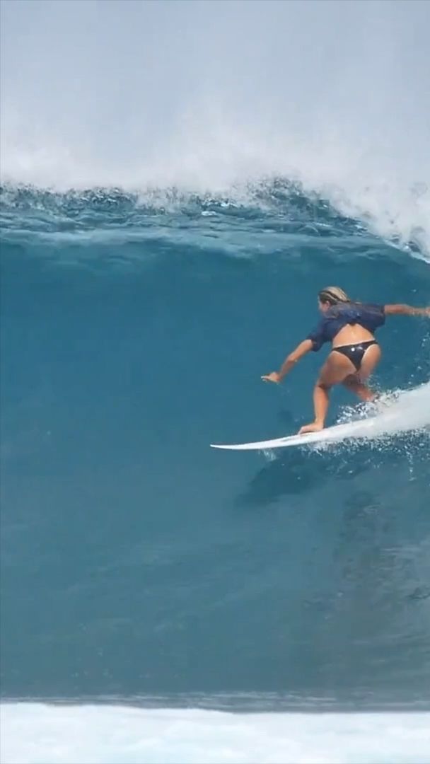 Female Surfer Riding Barrel Wave