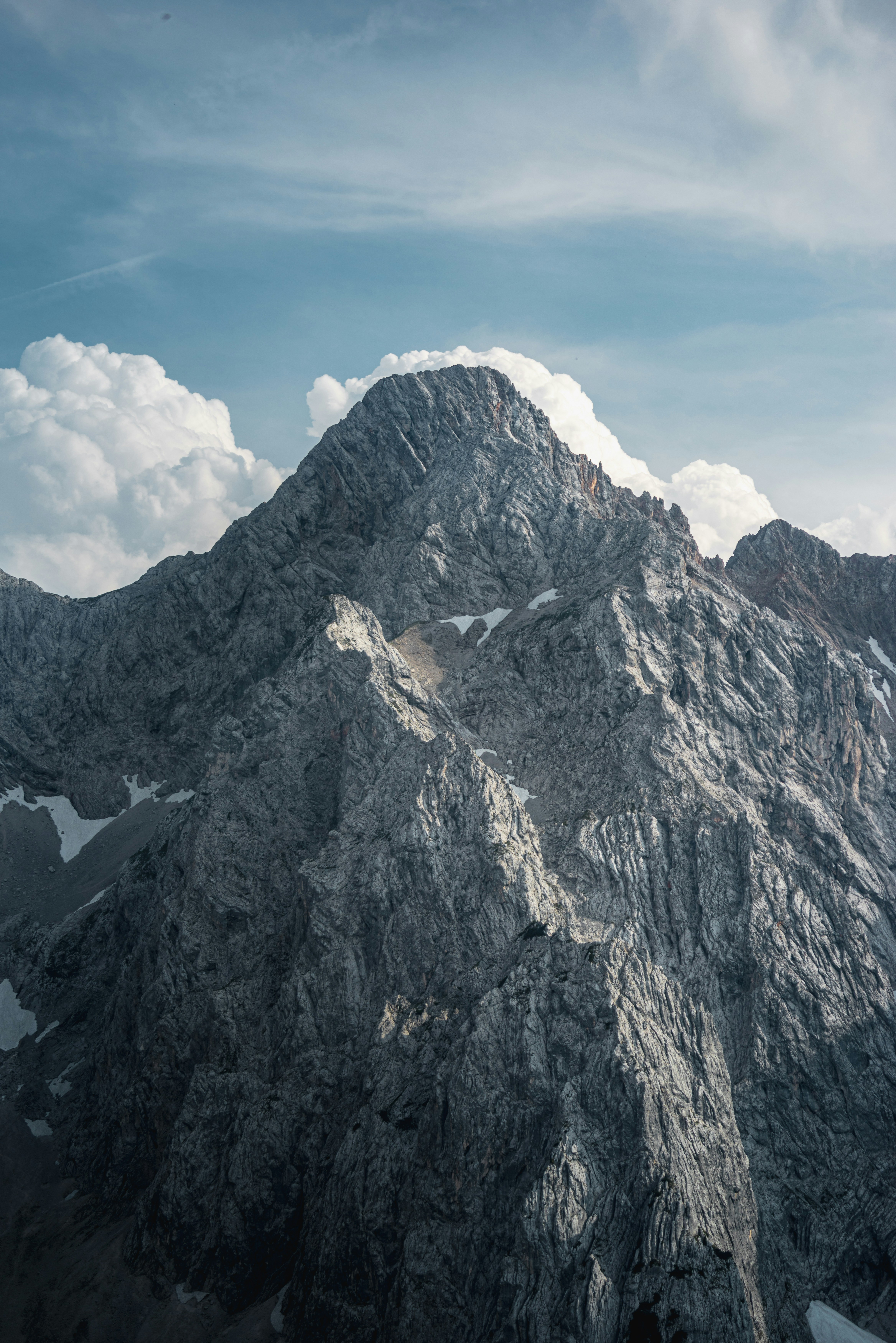 Rocky Mountain Peak Under Cloudy Sky