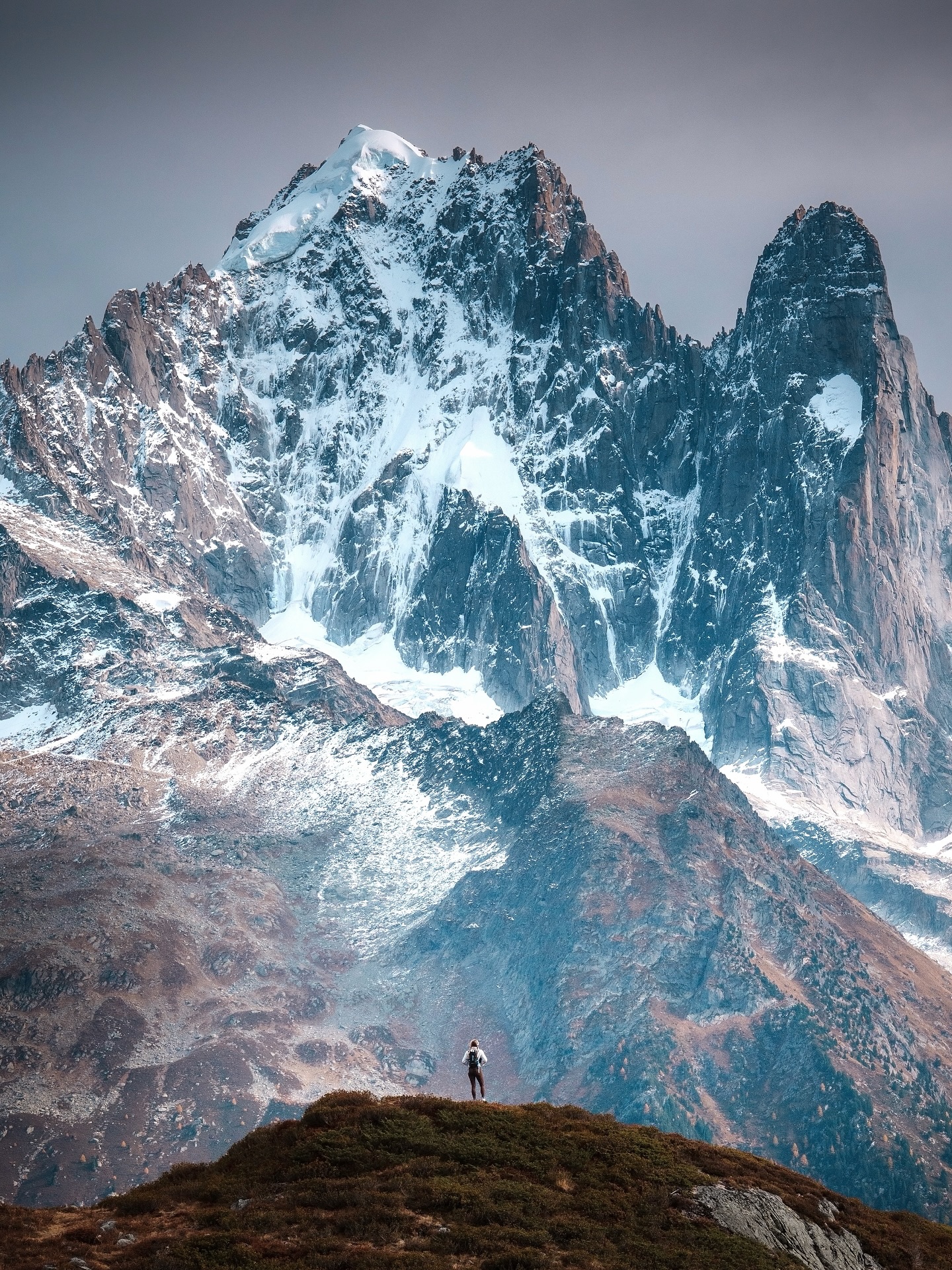 Hiker Overlooking Snowy Mountain Peaks