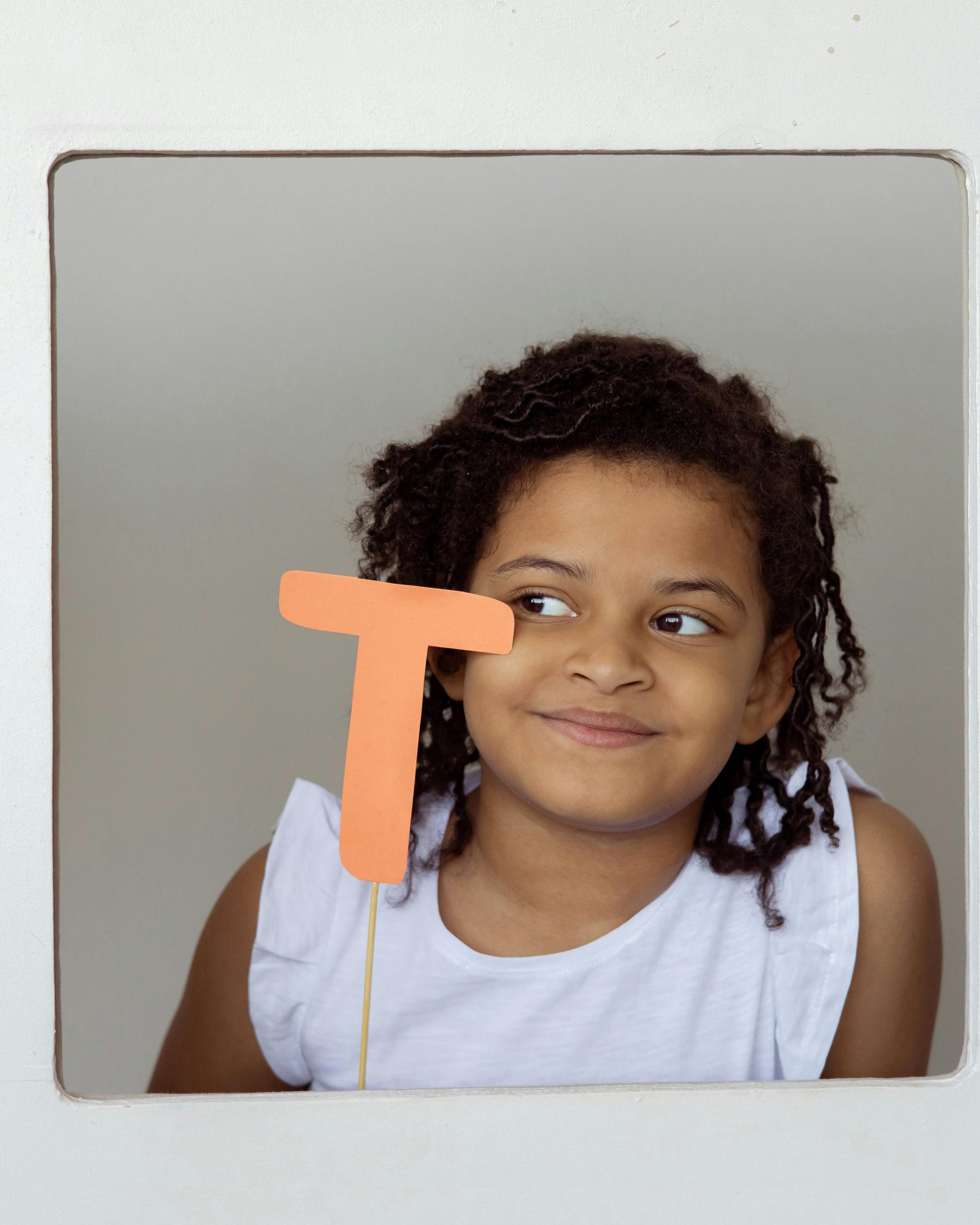 Girl Holding Paper Letter T