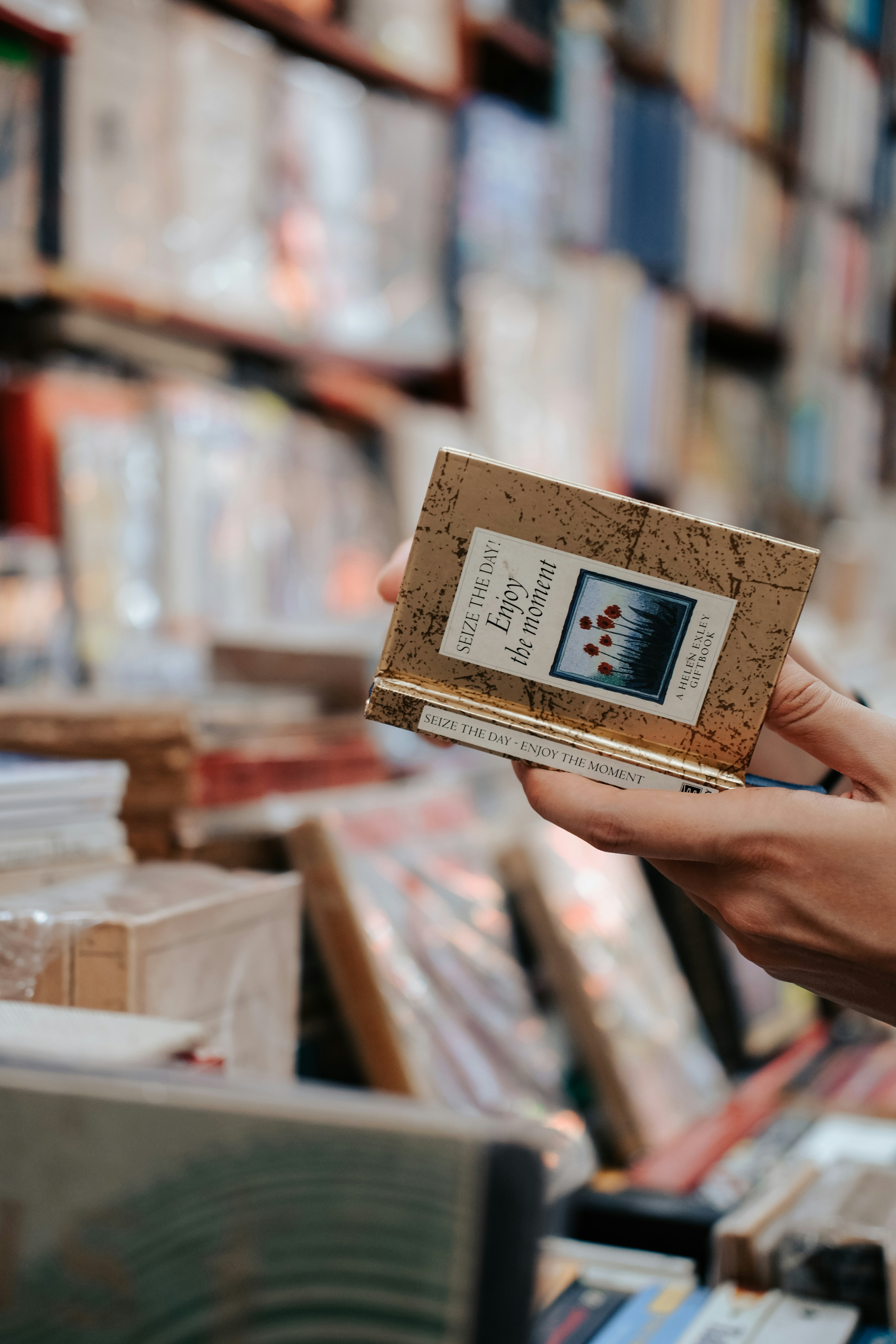 Hands Holding Gift Book in Bookstore