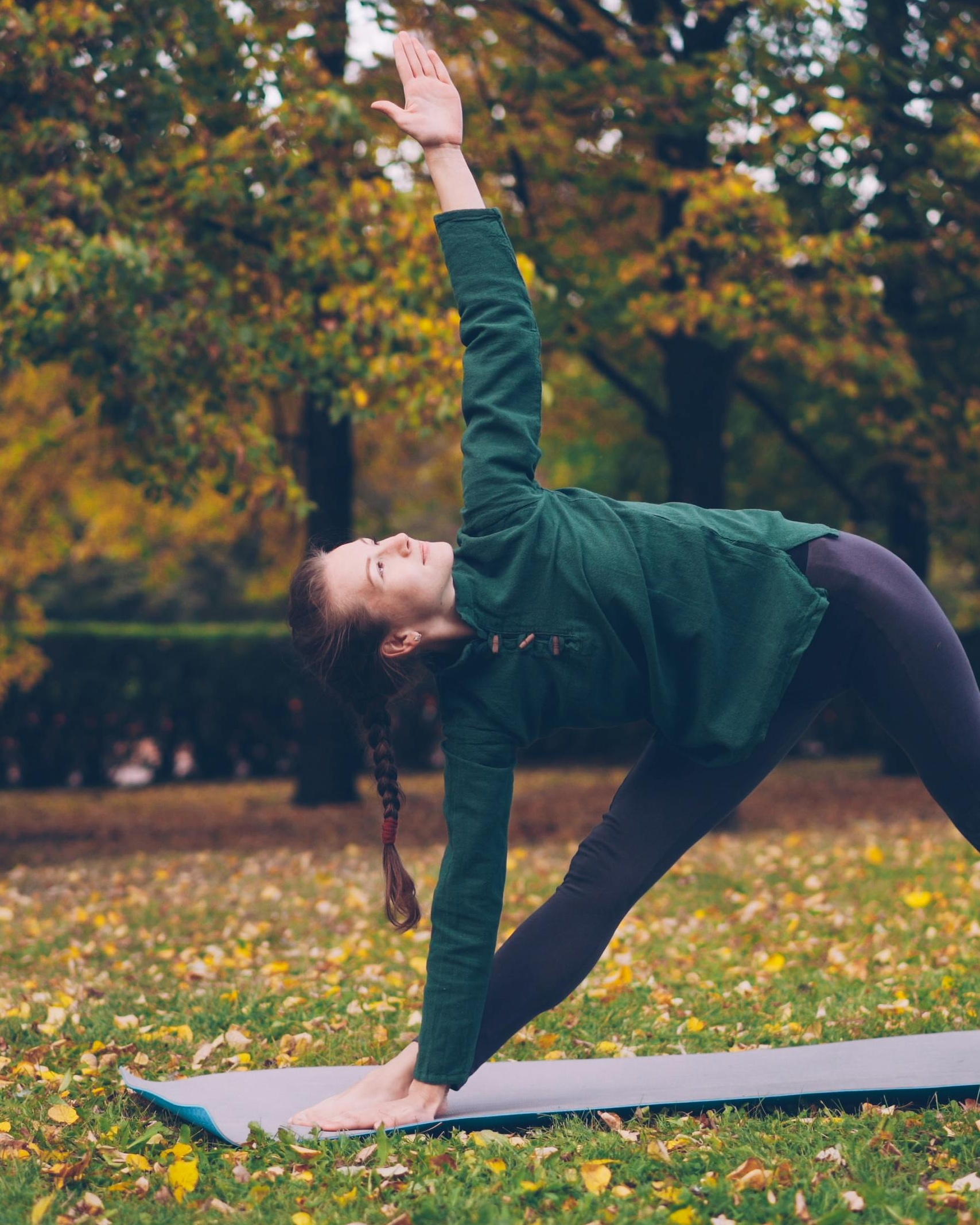 Woman Doing Yoga in Autumn Park