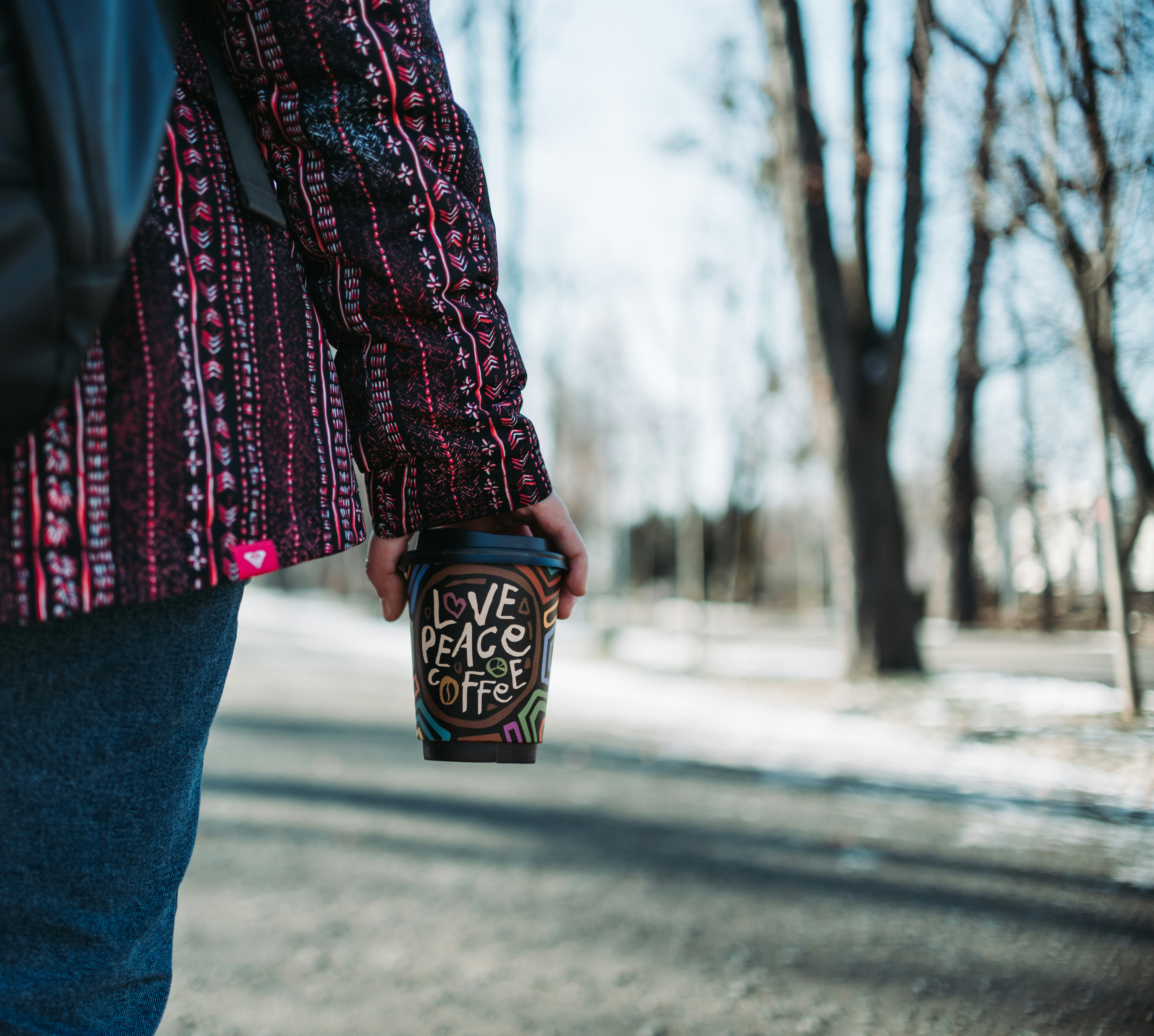 Person Holding Coffee on Winter Park Path