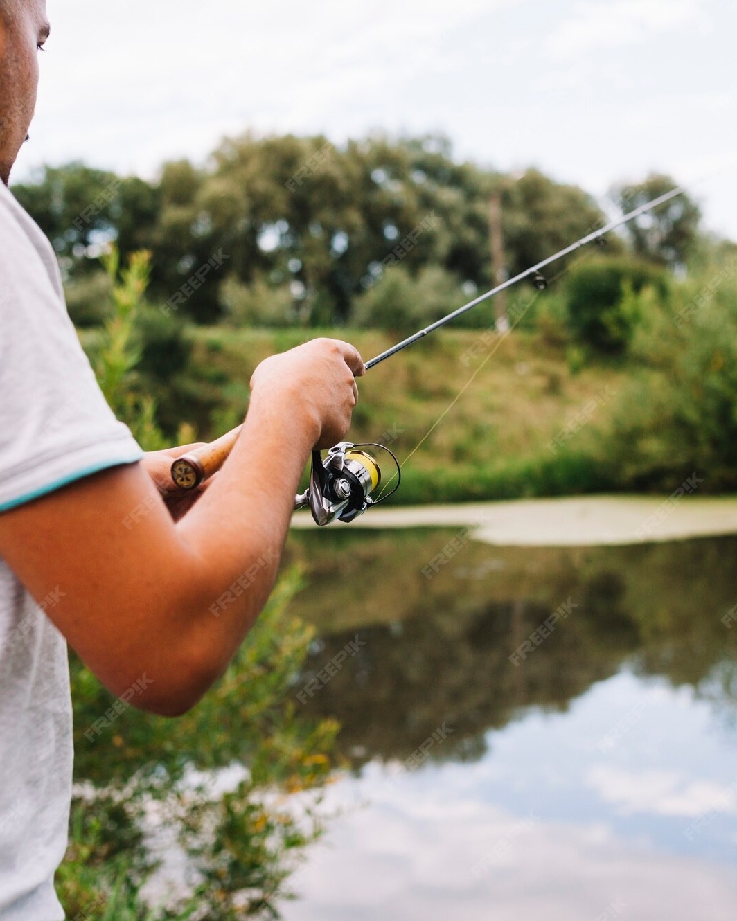 Man Fishing by Calm River