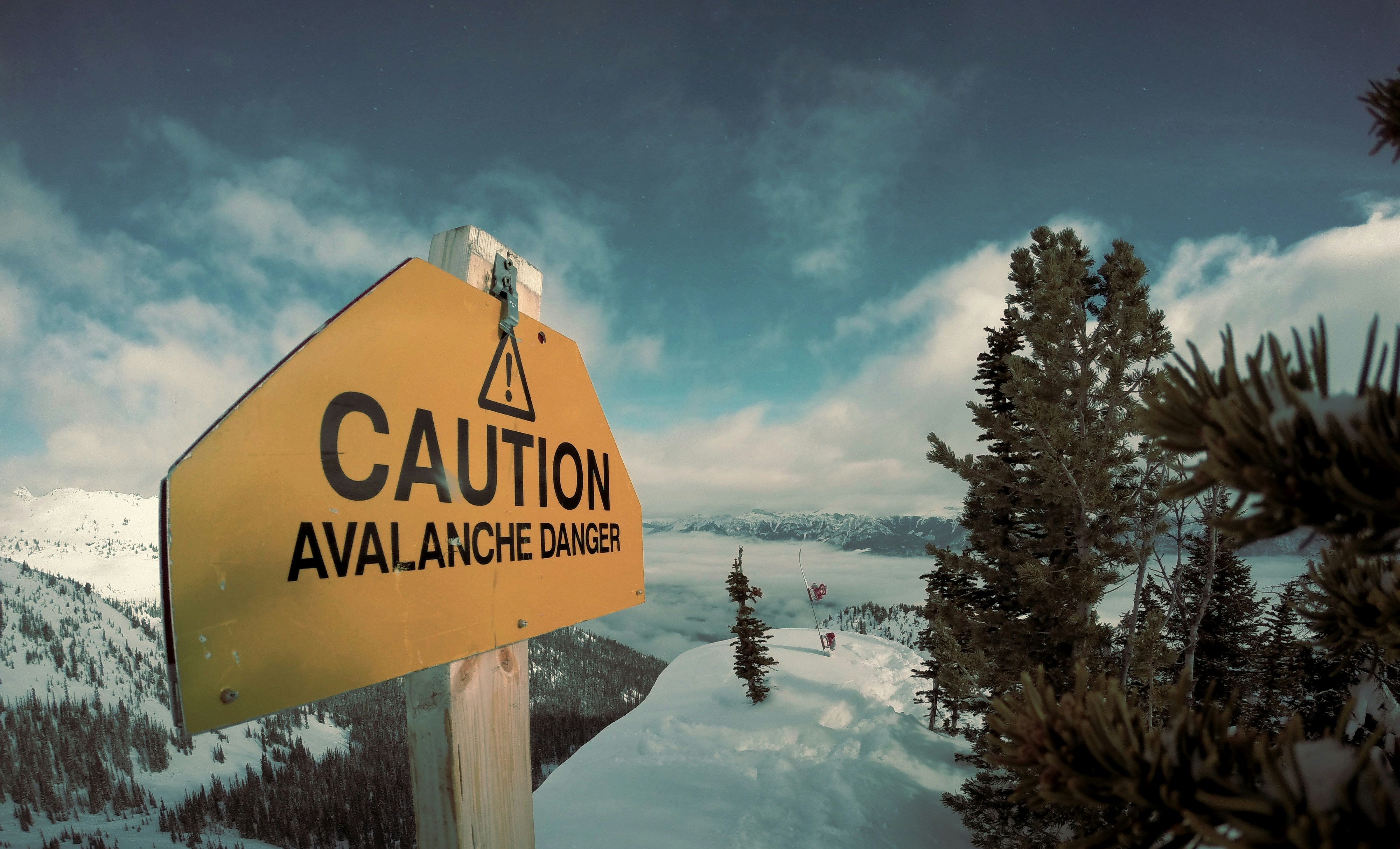 Avalanche Danger Warning Sign on Snowy Peak
