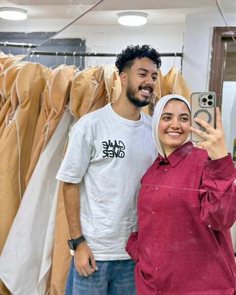 Couple Taking Mirror Selfie In Clothing Shop