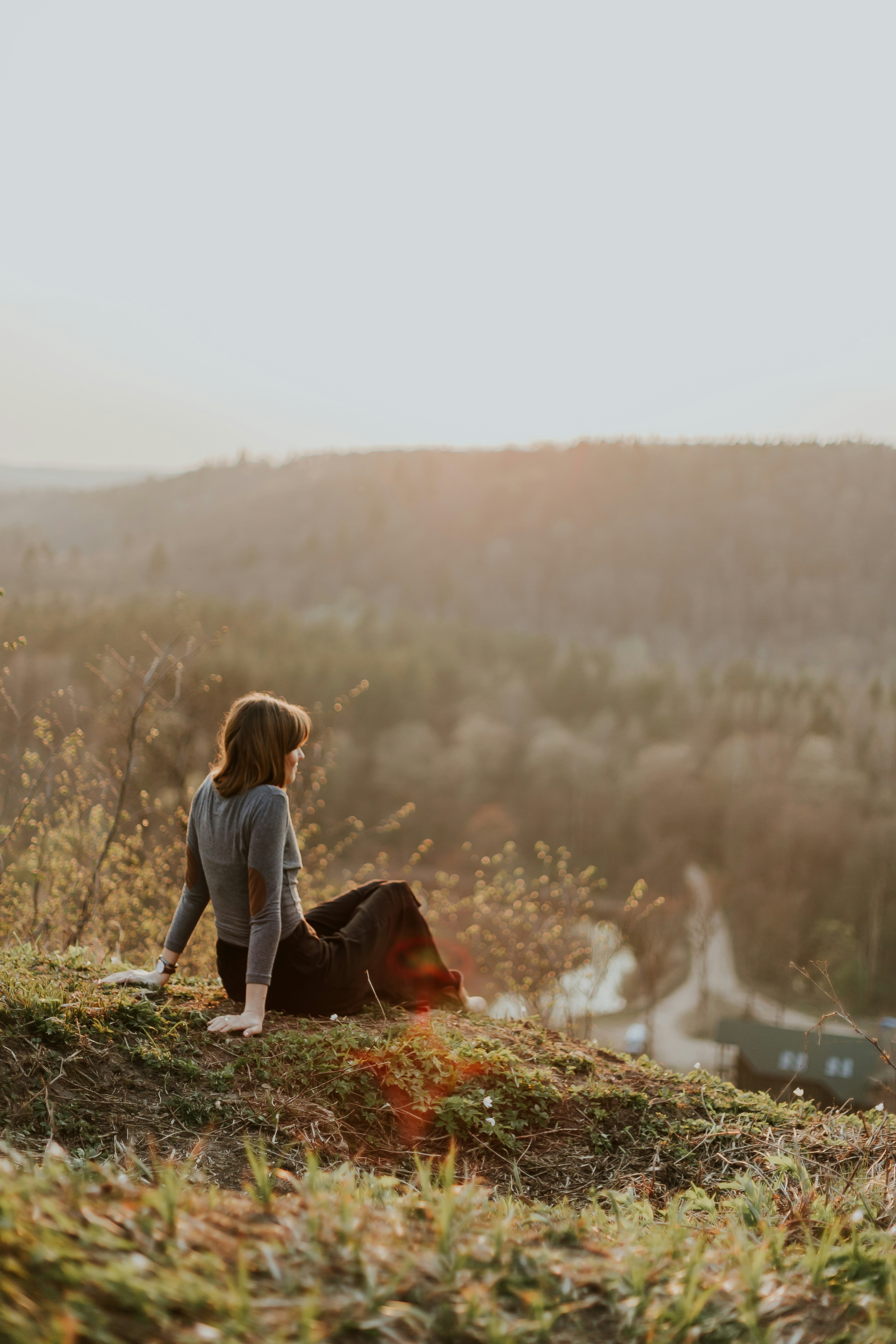 Woman Watching Sunset from Hilltop