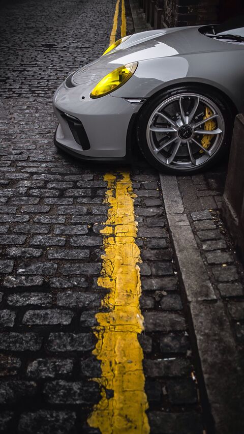 Grey Sports Car on Cobblestone Street