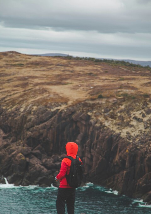 Hiker Overlooking Coastal Cliffs