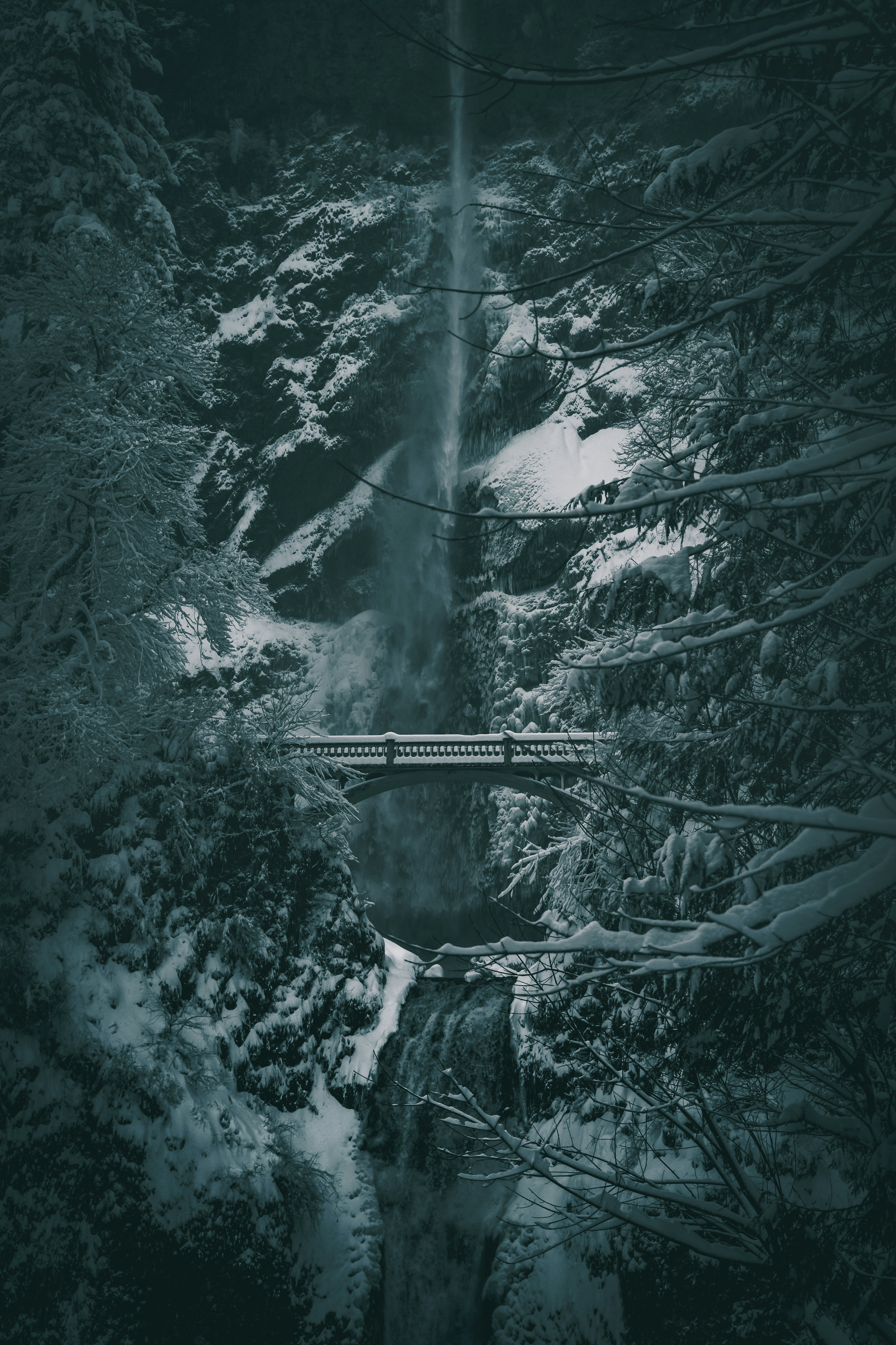 Snowy Winter Waterfall with Bridge