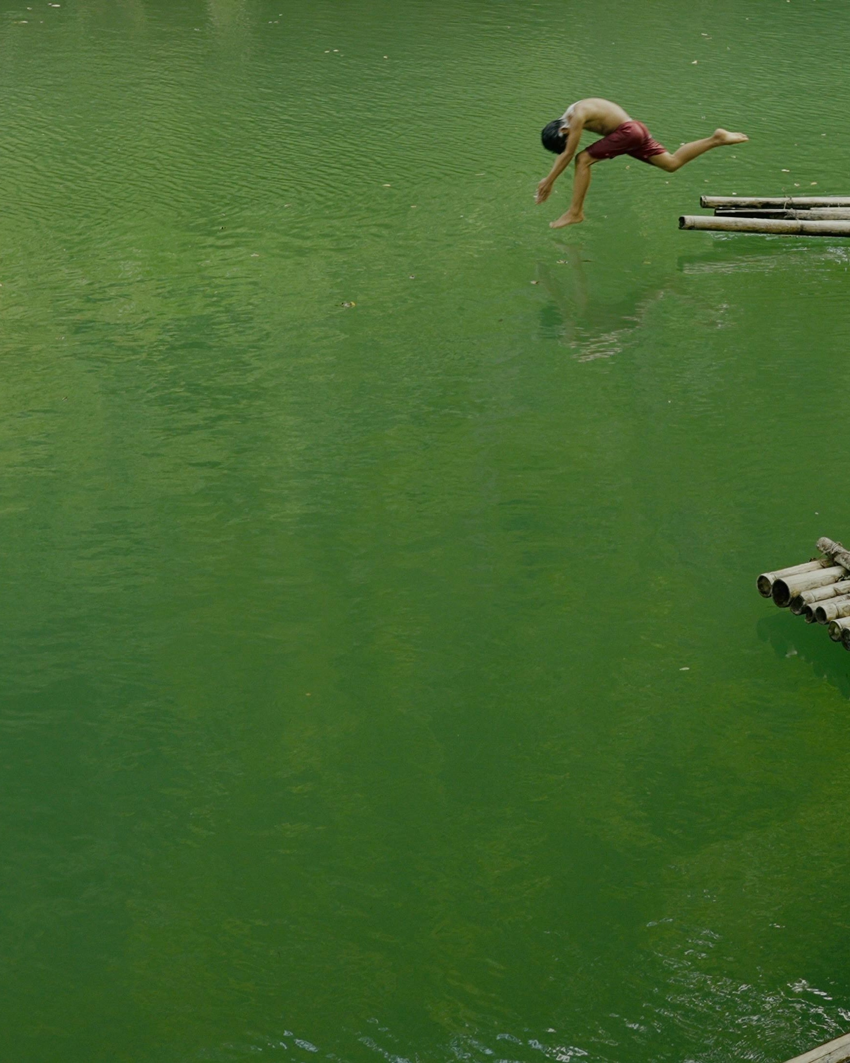 Boy Diving Into Green River Water