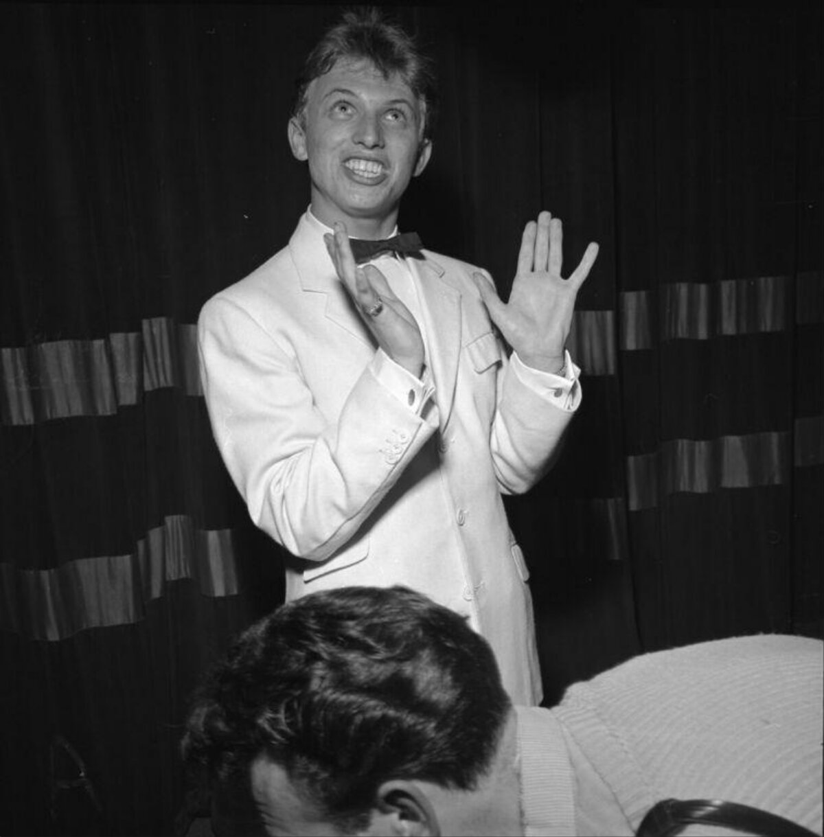 Male Performer Clapping on Stage