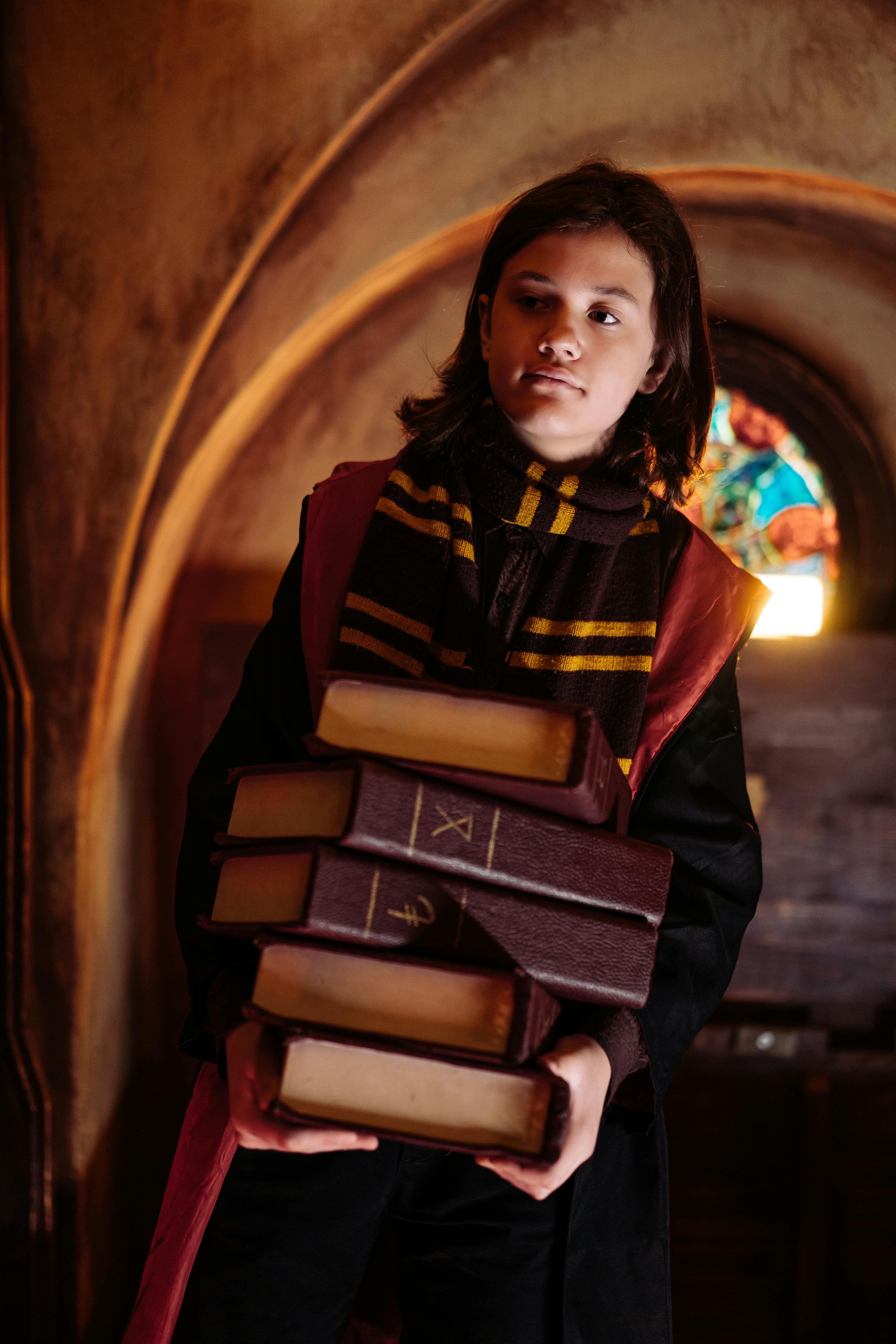 Wizard Student Holding Stack of Books