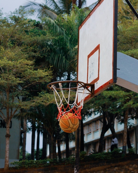 Basketball Passing Through Outdoor Hoop