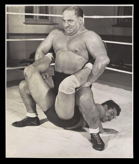 Two Wrestlers Competing In Ring