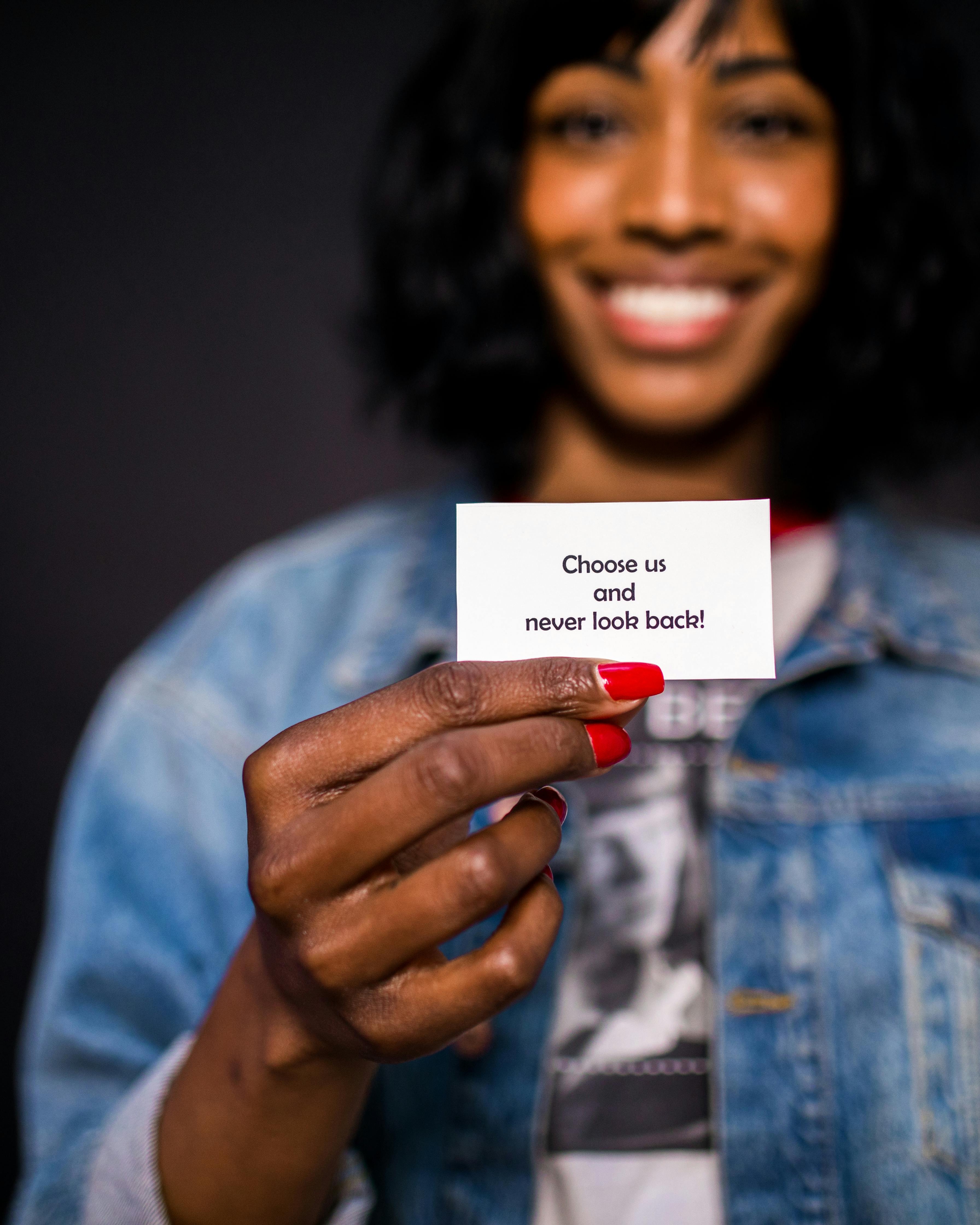 Smiling Woman Holding Promotional Card