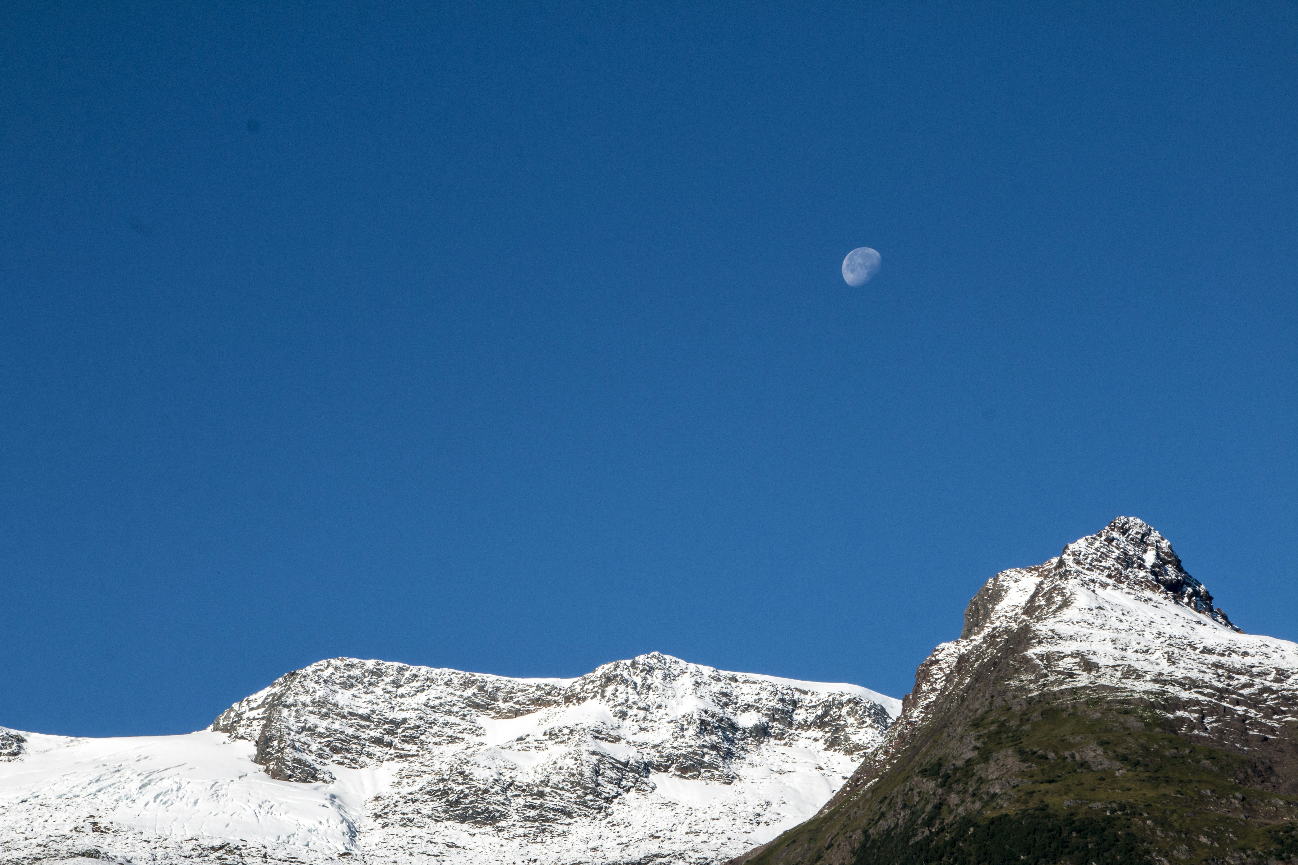 Moon Over Snow-capped Mountain Peaks