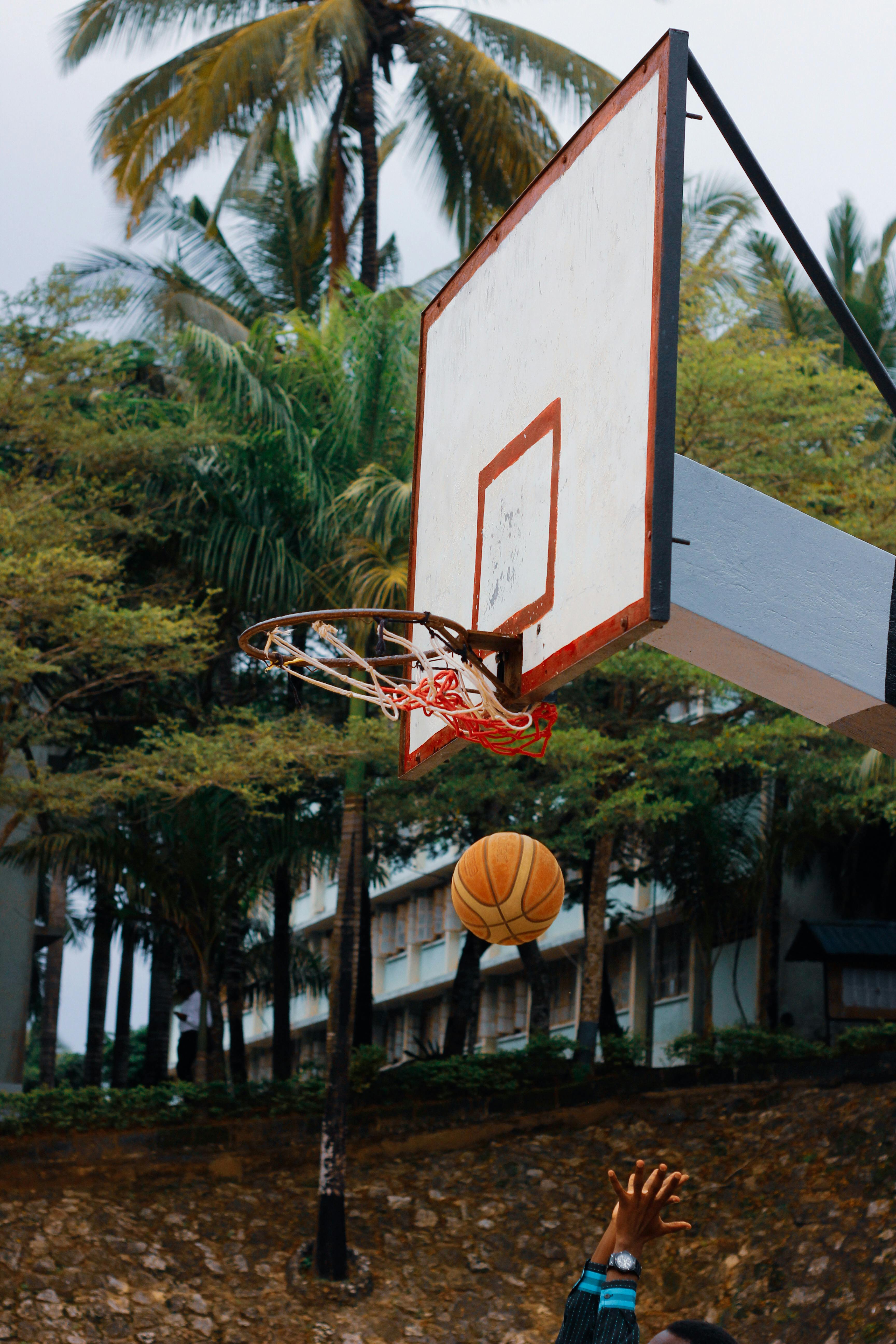 Shooting Basketball at Outdoor Hoop
