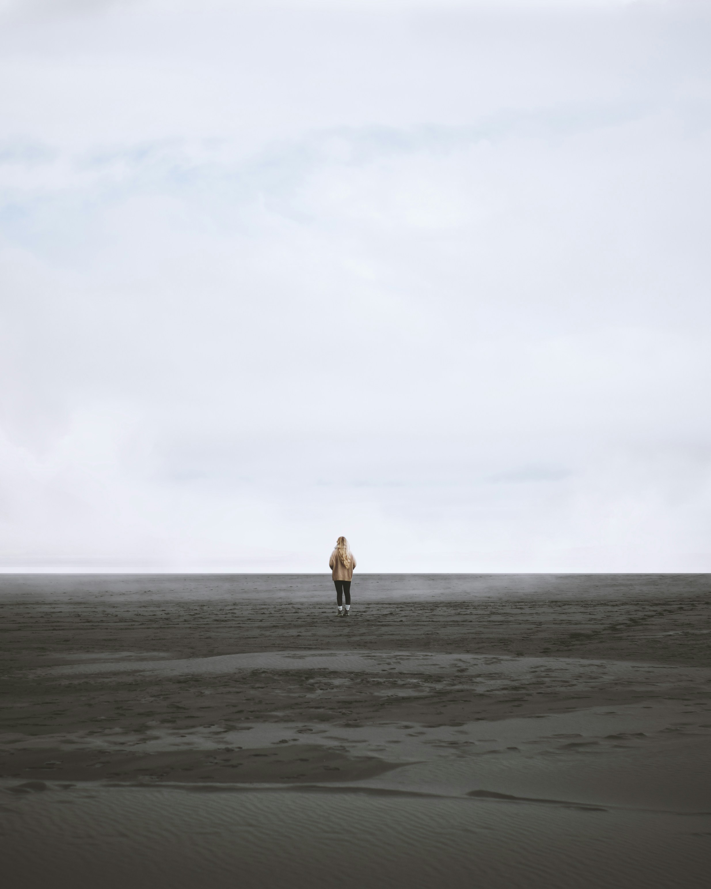 Woman Standing Alone on Vast Open Land