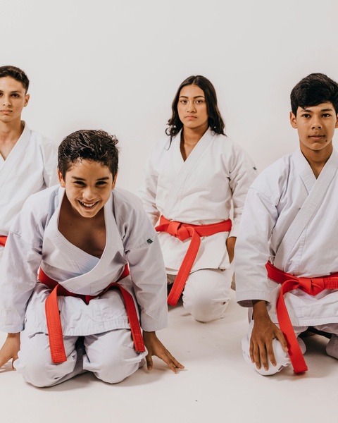 Four Young Karate Students with Red Belts