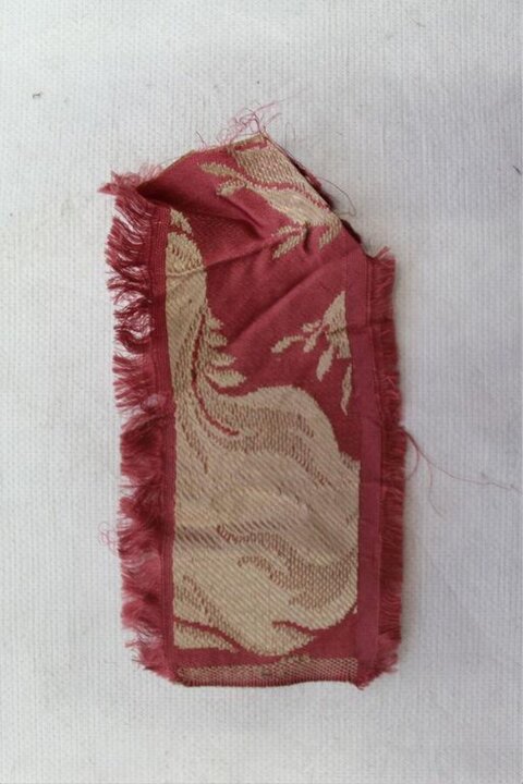 Frayed Red Textile Fragment With Pattern