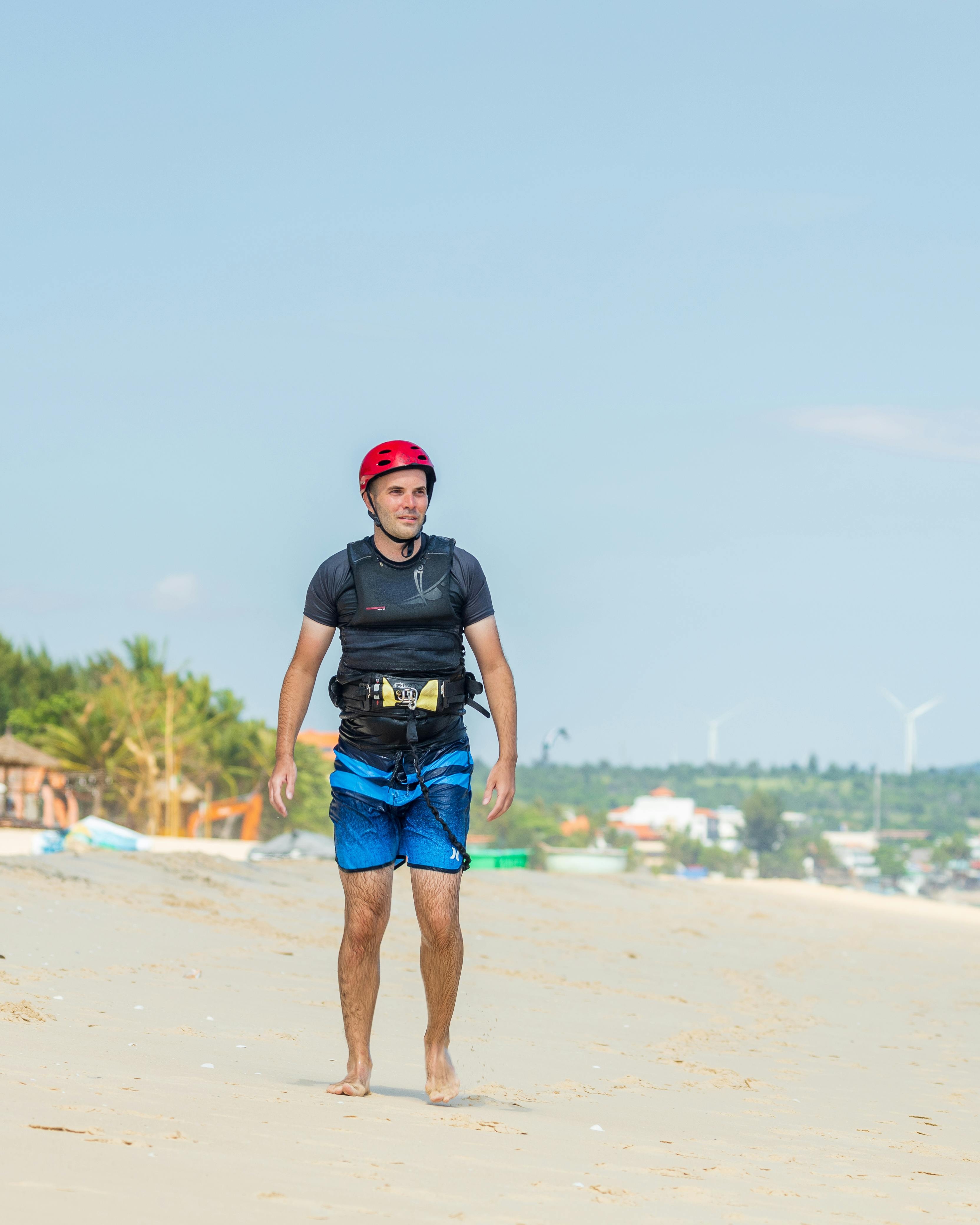 Kitesurfer Walking on Sandy Beach