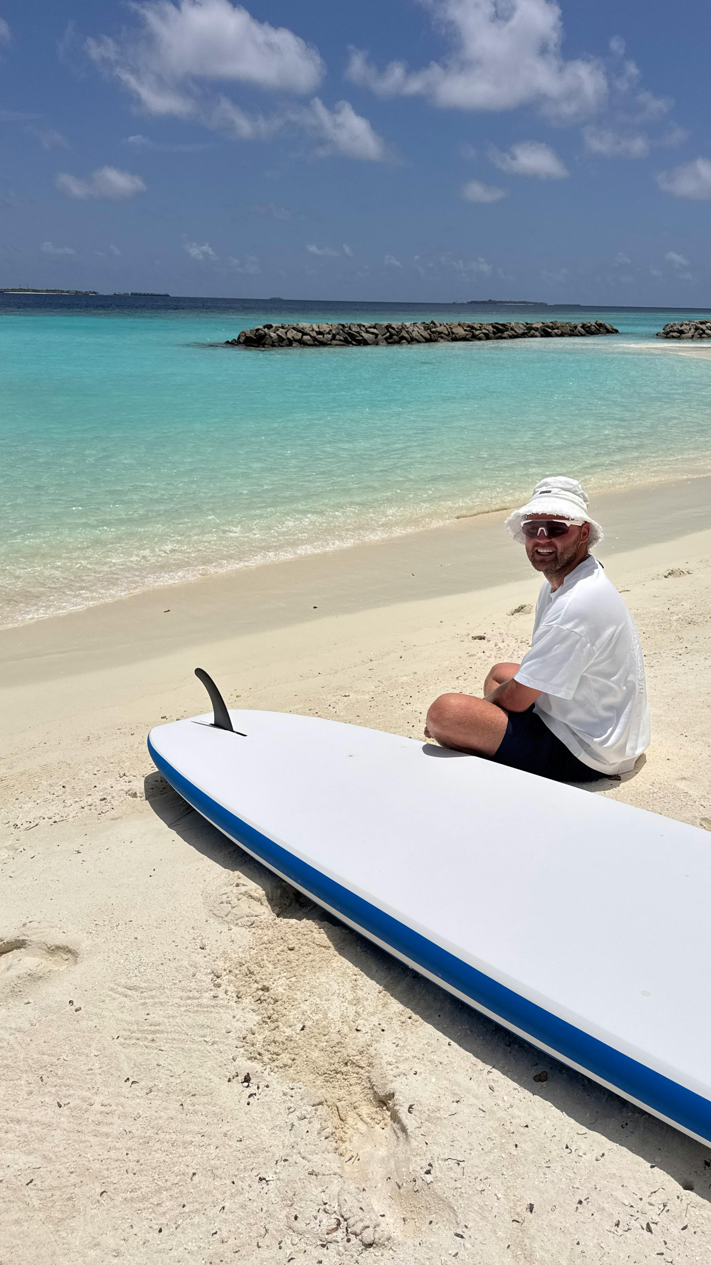 Man With Paddleboard on Tropical Beach
