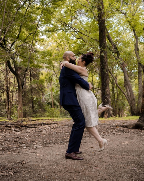 Joyful Wedding Couple Embracing In Woods