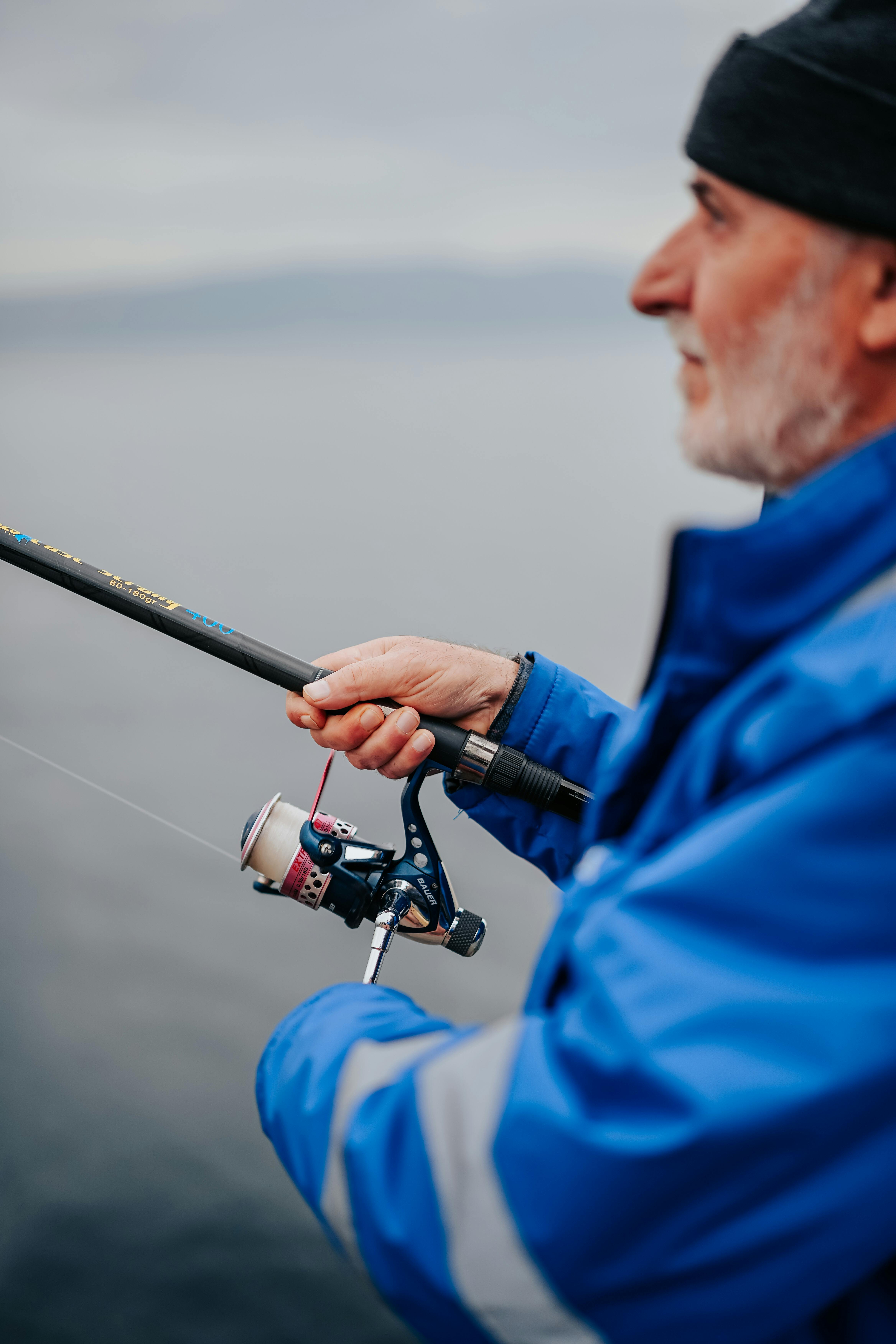 Older Man Fishing on Calm Water
