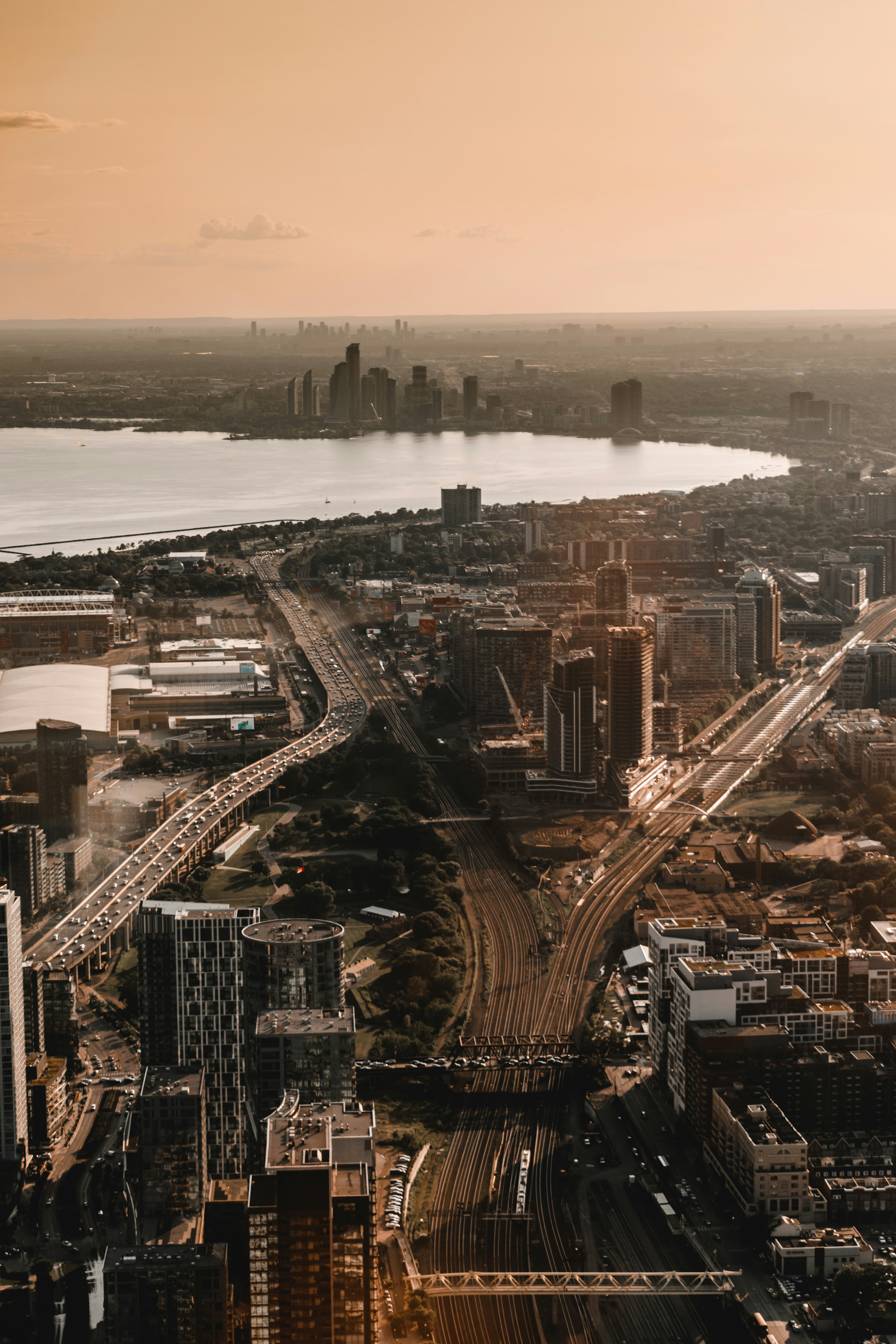 Aerial View of Lakeside City at Sunset — City