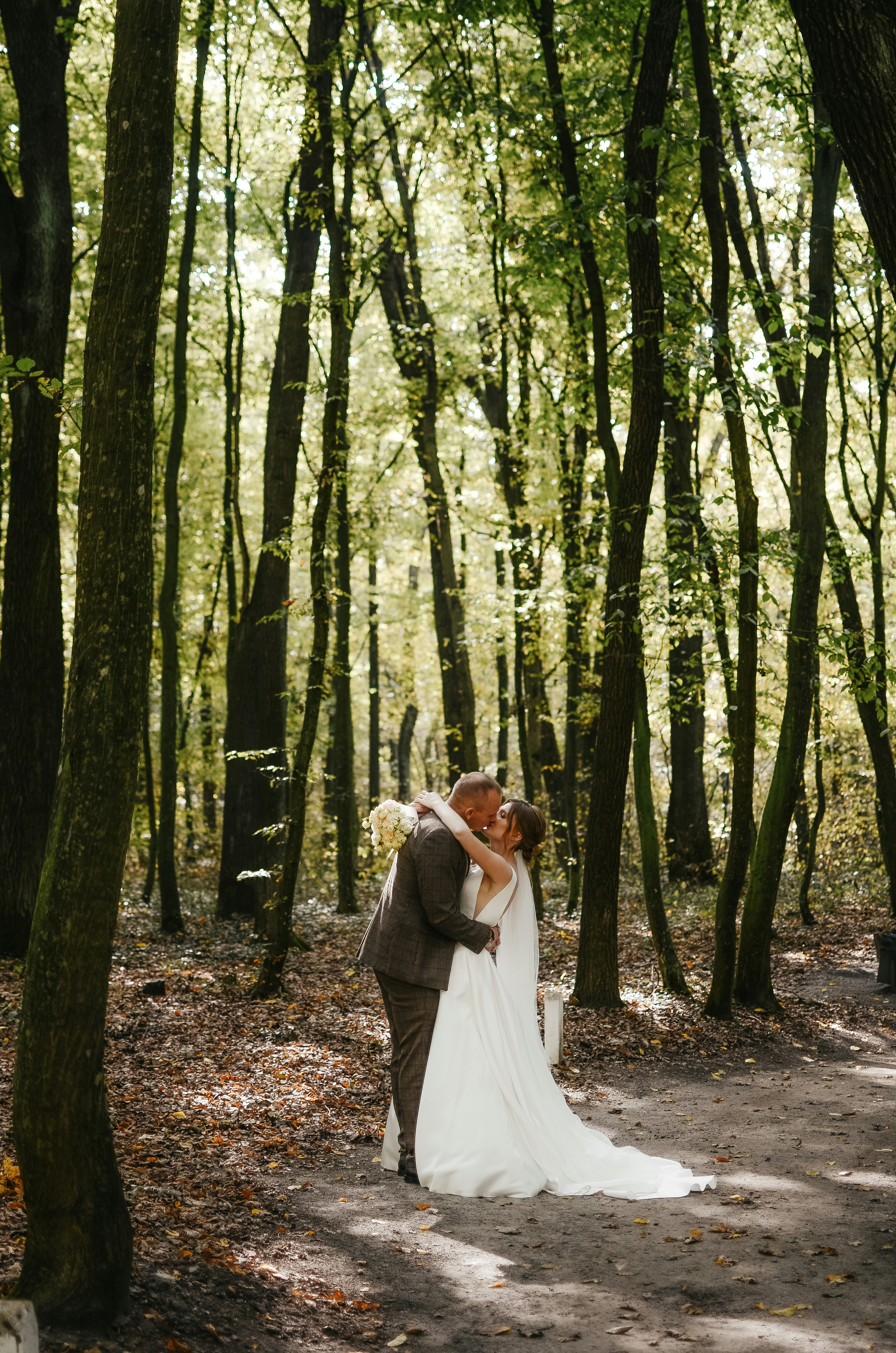 Wedding Couple Kissing In Forest