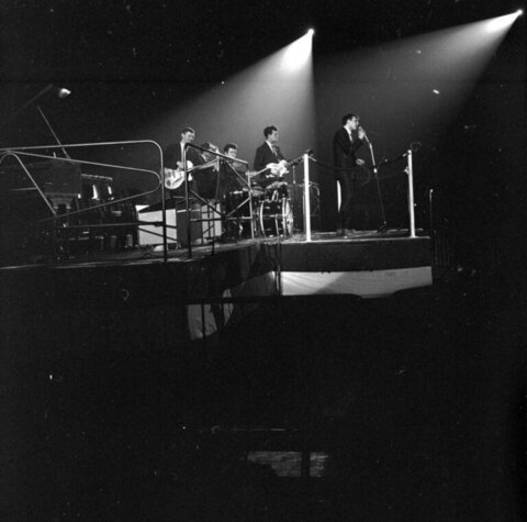 Band Performing On Stage Under Spotlights