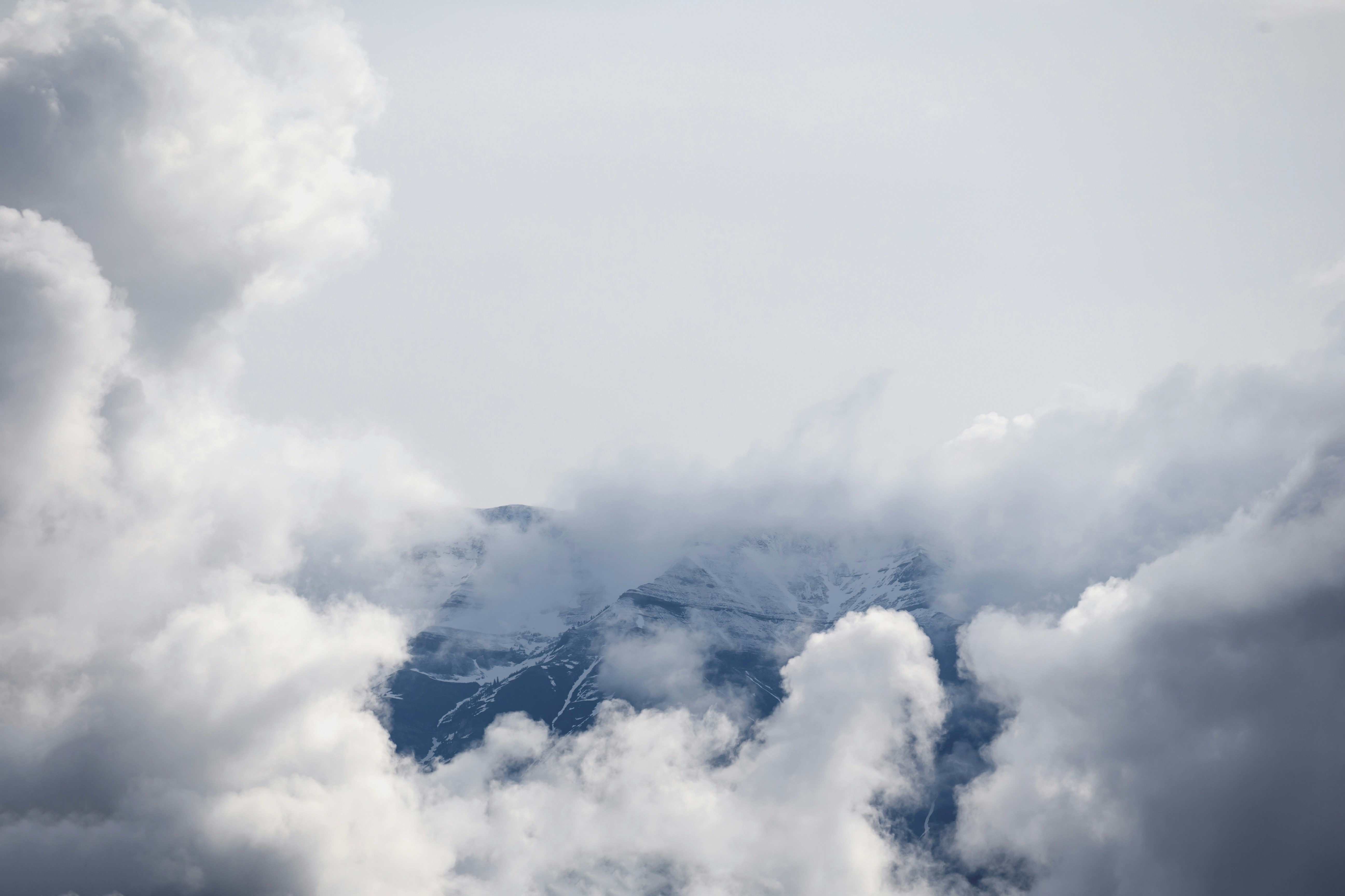 Snow Mountain Through Clouds