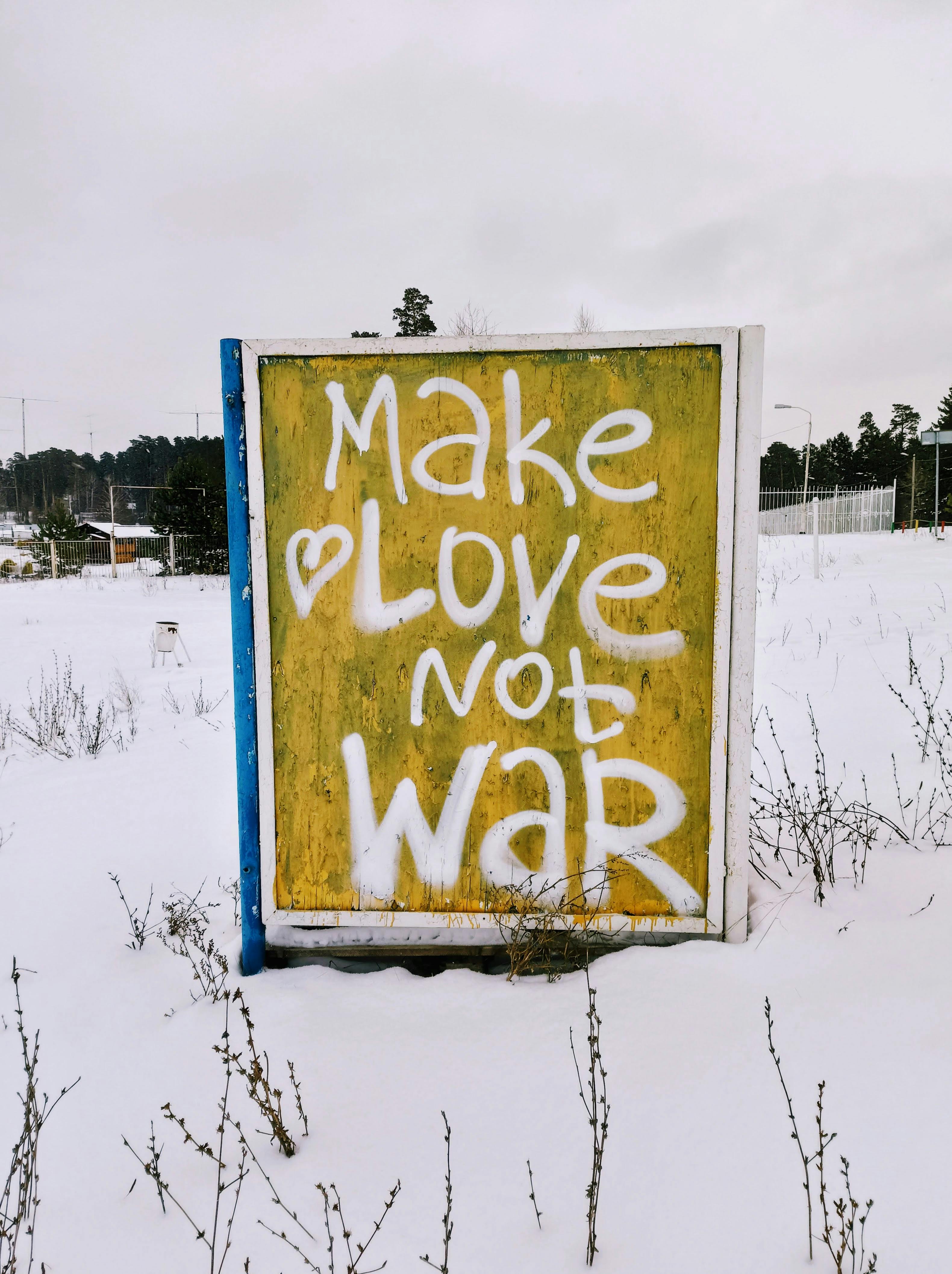 Make Love Not War Sign In Snowy Field