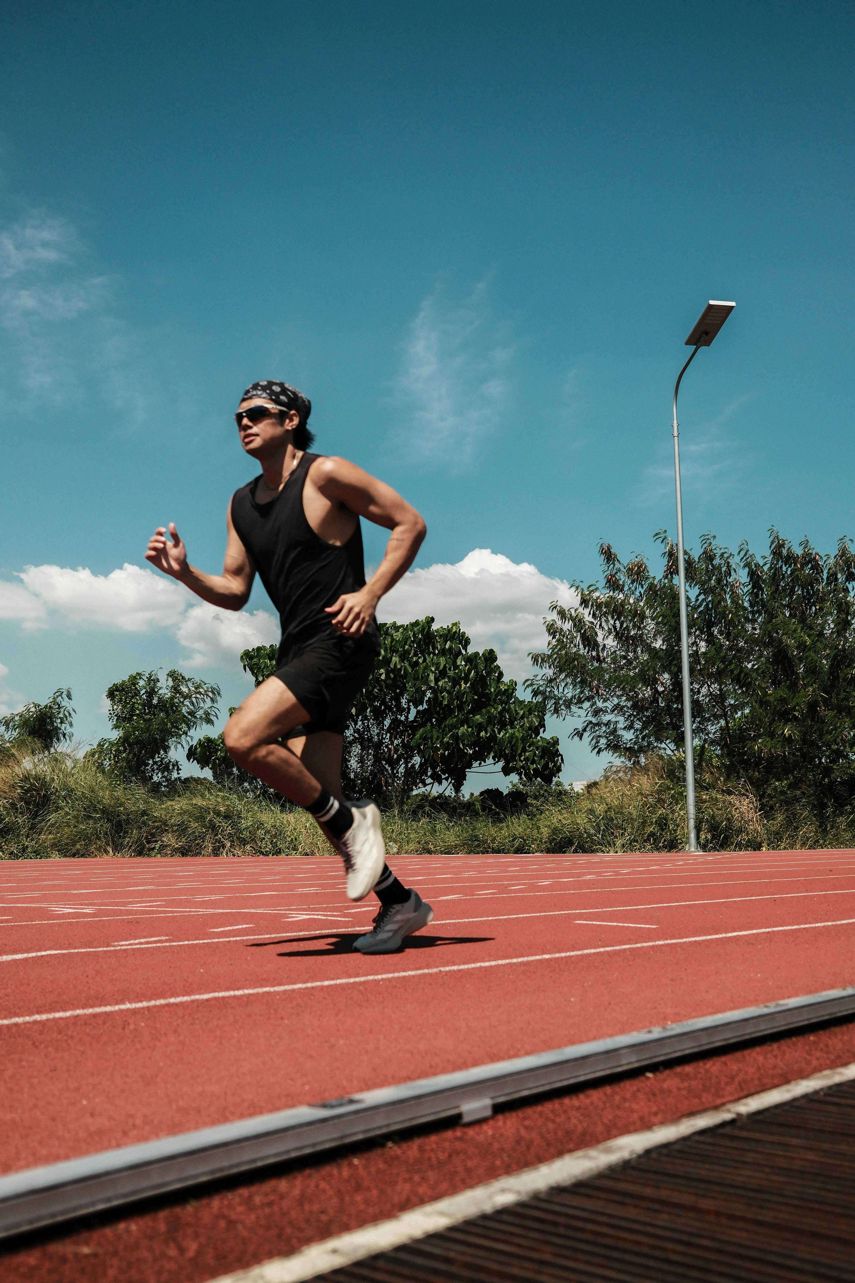 Man Running on Outdoor Running Track